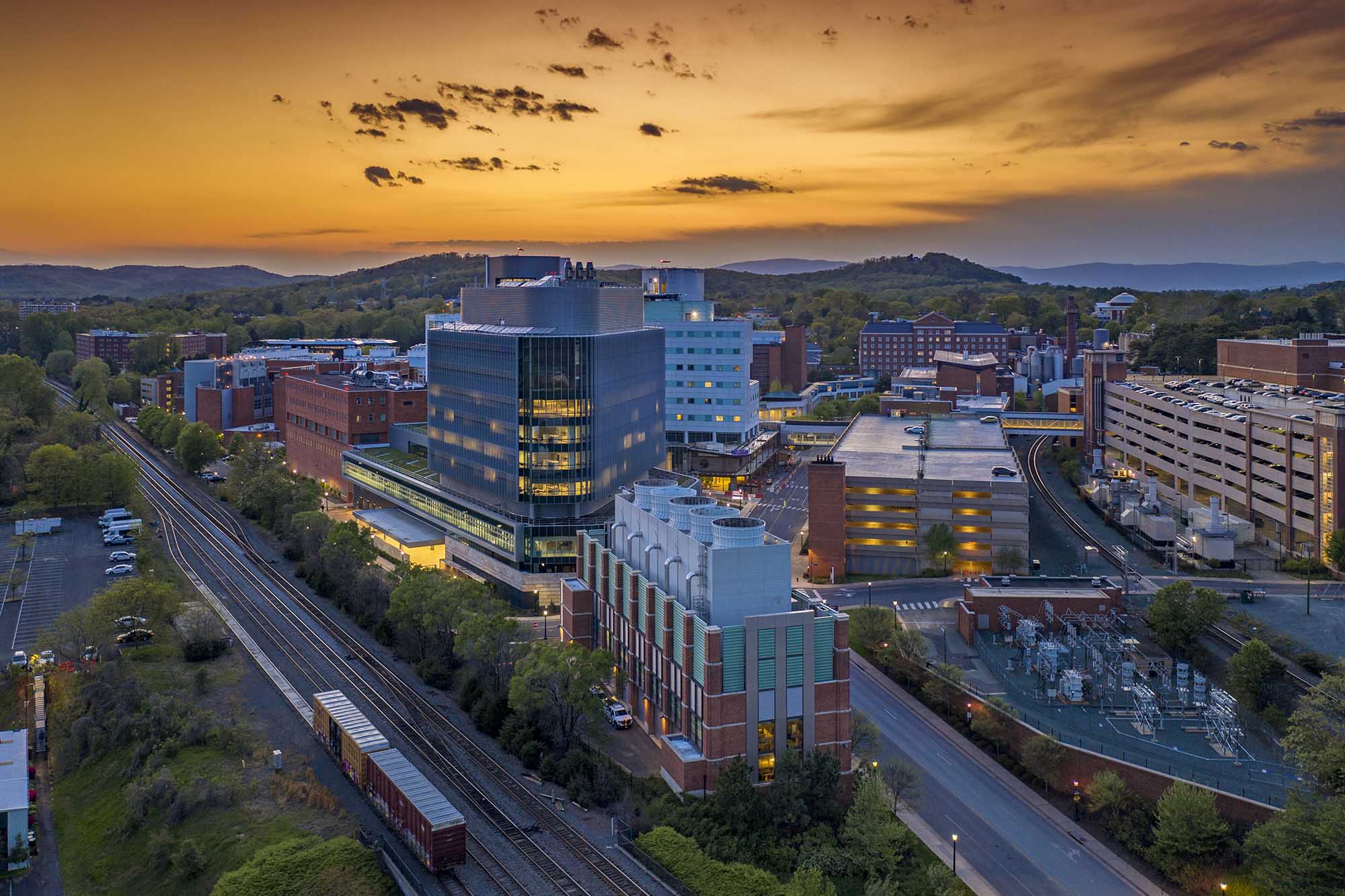 Aerial view of the UVA Health Center Buildings during a orange sunset