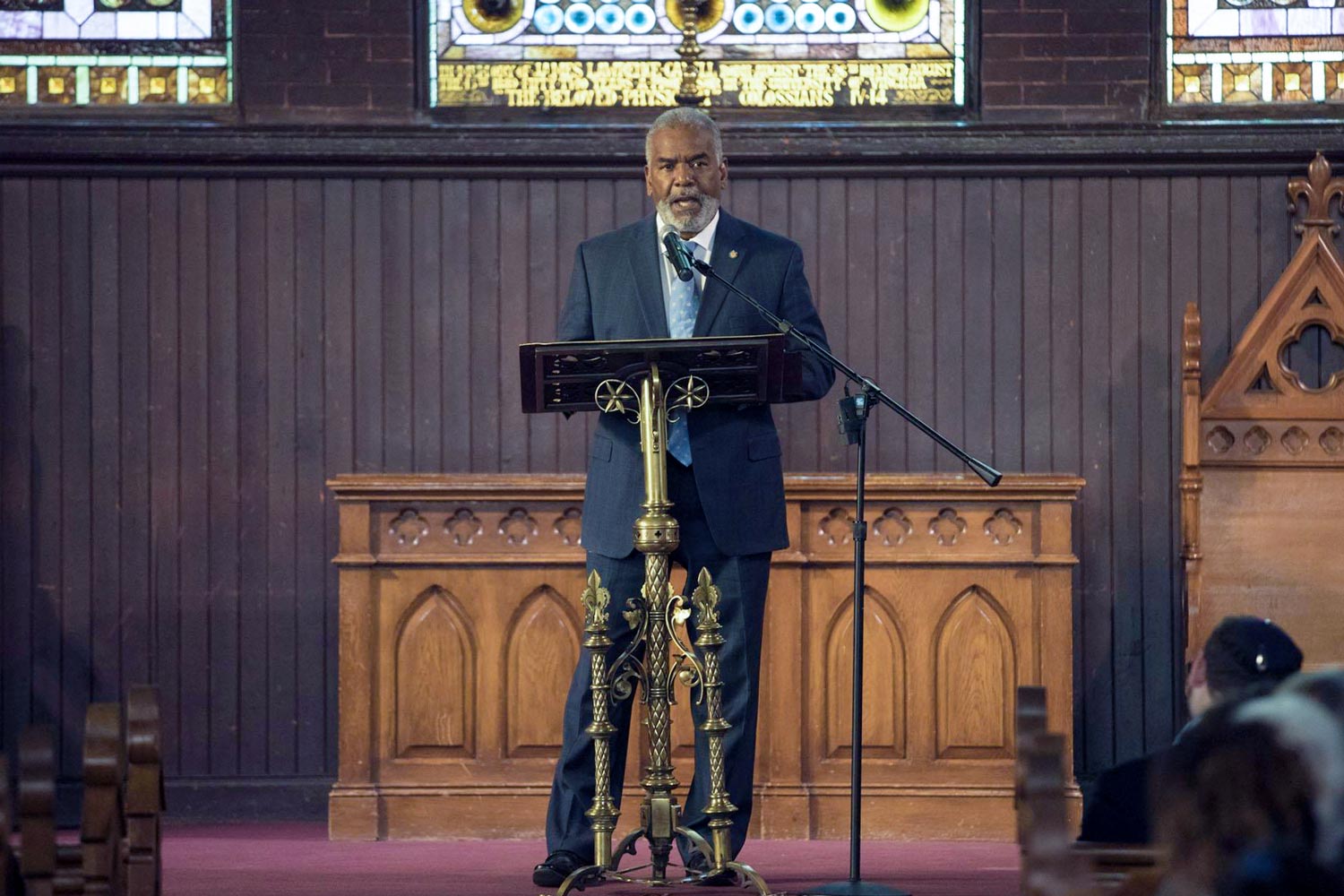 Dr. Marcus Martin speaking at a pulpit