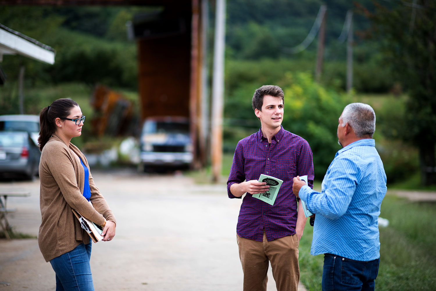 Siarra Rogers and R. Cooper Vaughan talking to a farmer