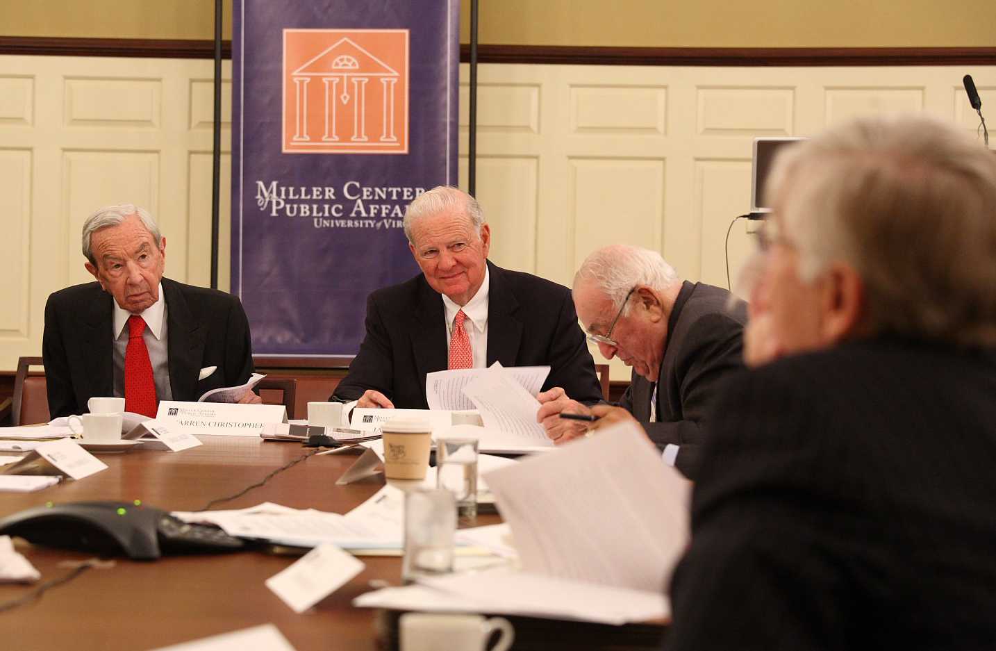  Warren Christopher, left, and James Baker, right, lsiten to a man talking from a table