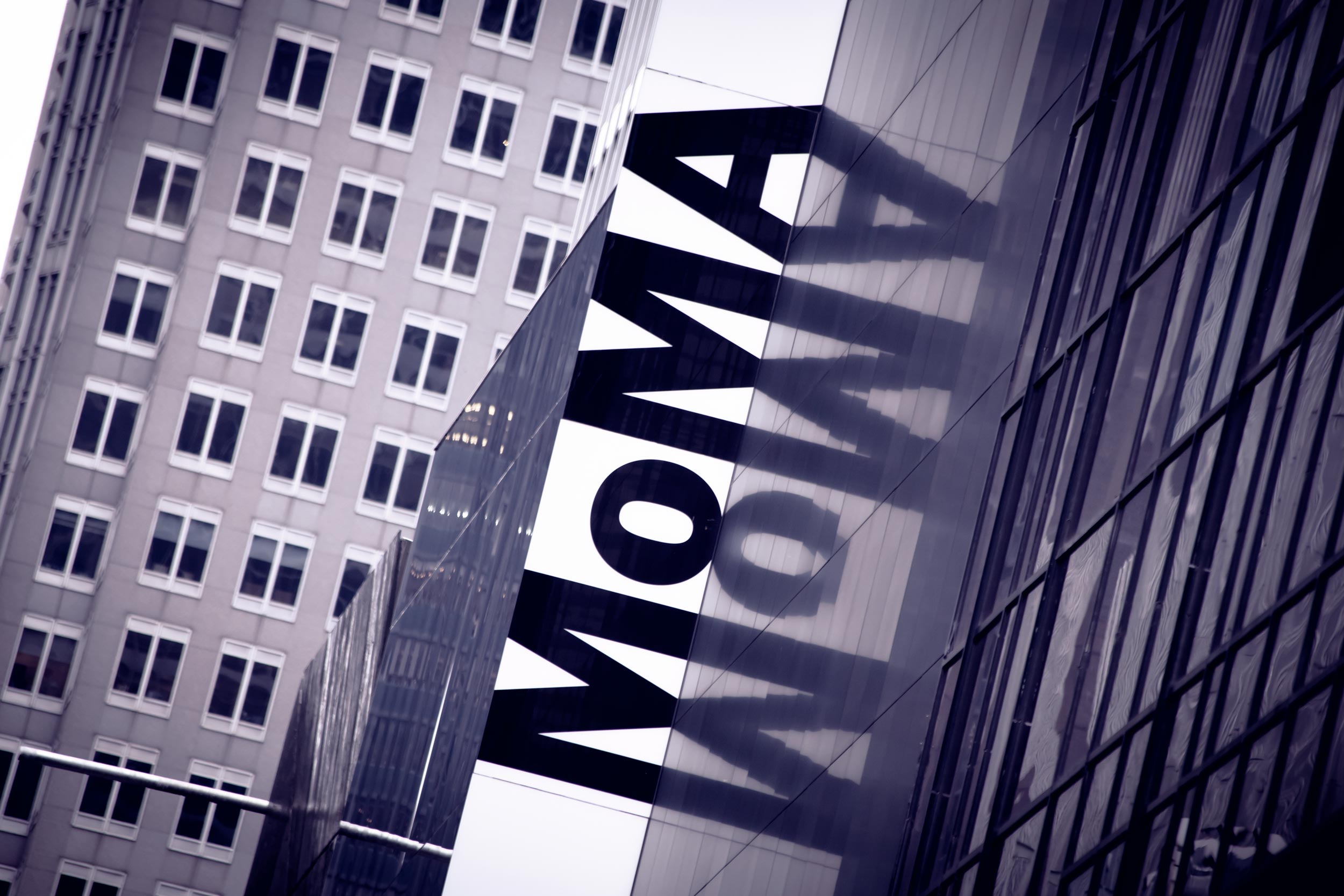 Sign on a building that says Moma