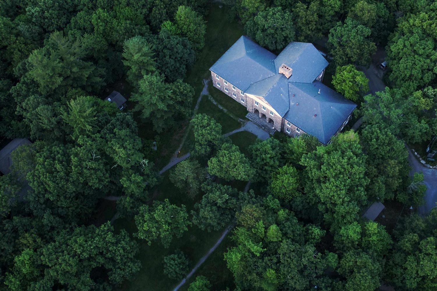 Aerial view of UVA's brick Mountain lake biological station surrounded by trees