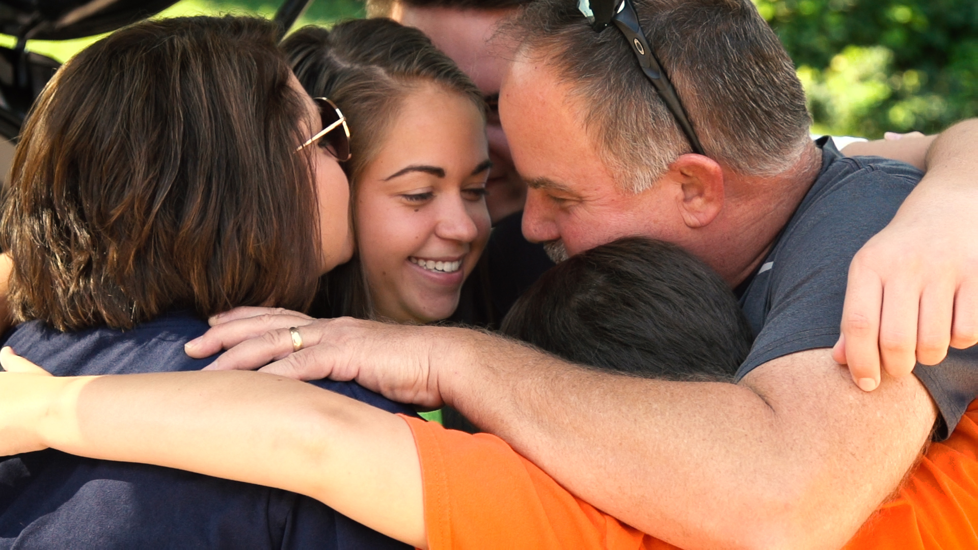 Family gives a student a group hug