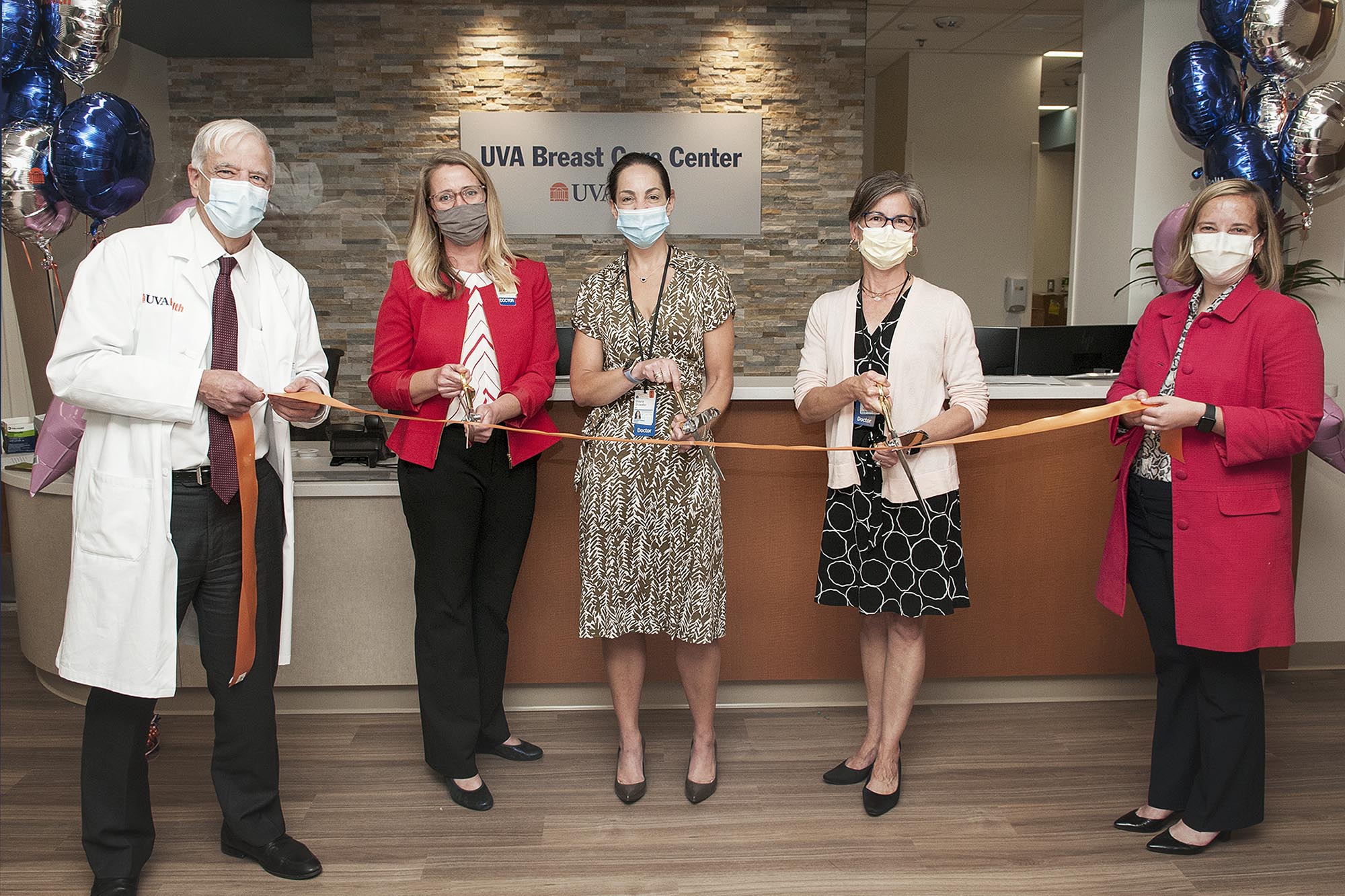 Dr. Craig Kent,Dr. Carrie Rochman, Dr. Shayna Showalter, Dr. Christiana Brenin, Dr. Carrie Rochman, Dr. Shayna Showalter, Dr. Christiana Brenin, cut a orange ribbon as the grand opening of the UVA Breast Care Center