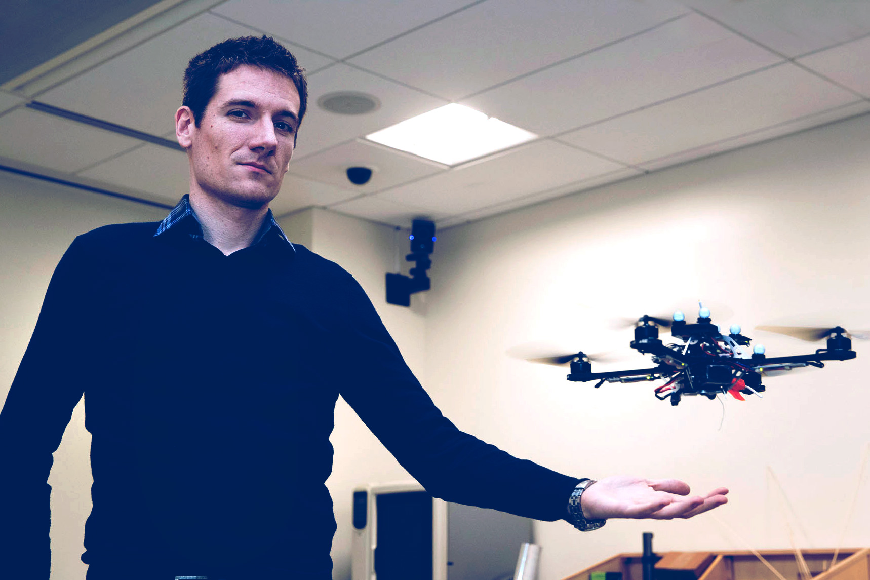 Nicola Bezzo holds his hand out as a drone floats over his hand