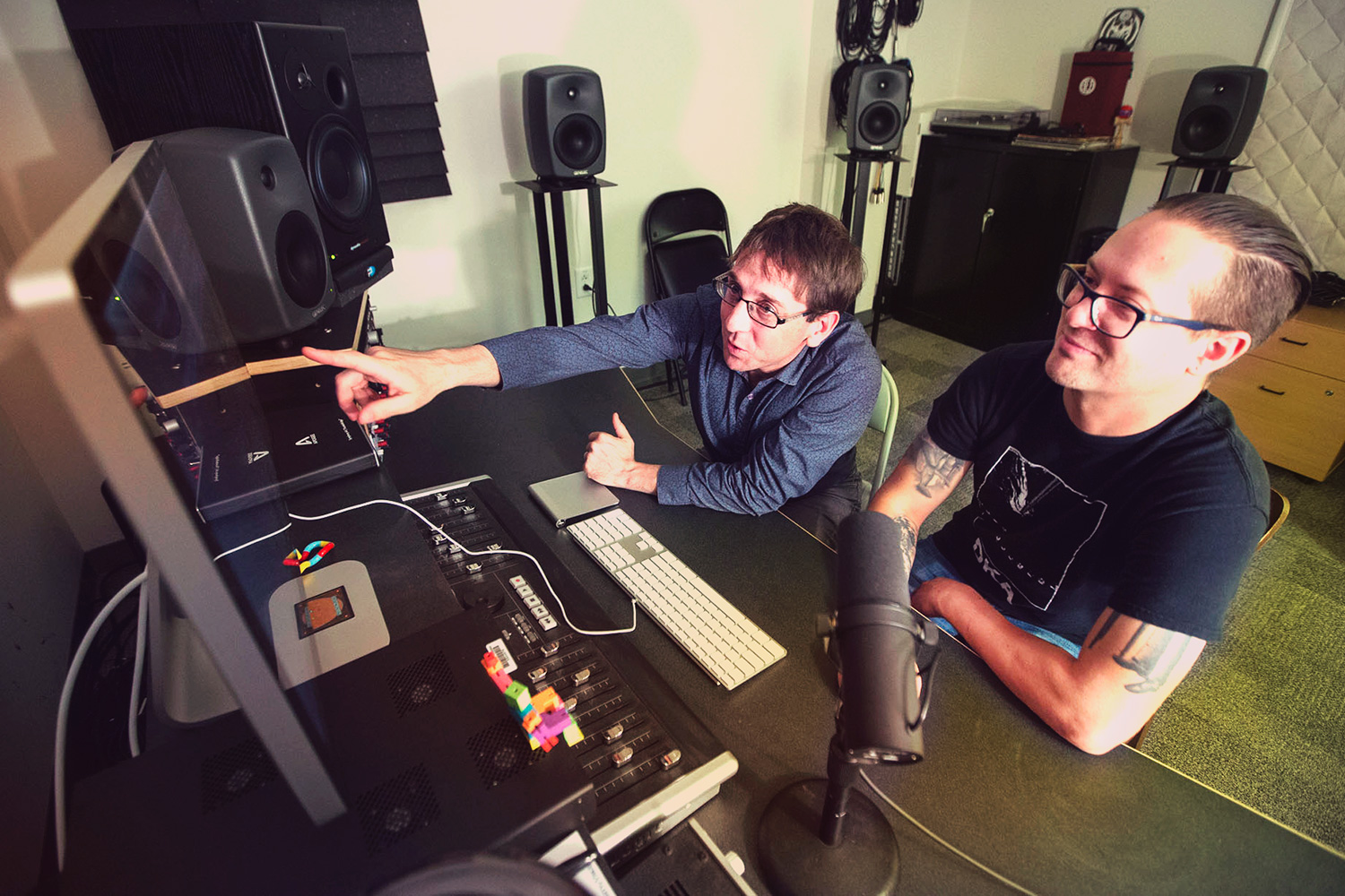 Noel Lobley and Travis Thatcher work together on a computer