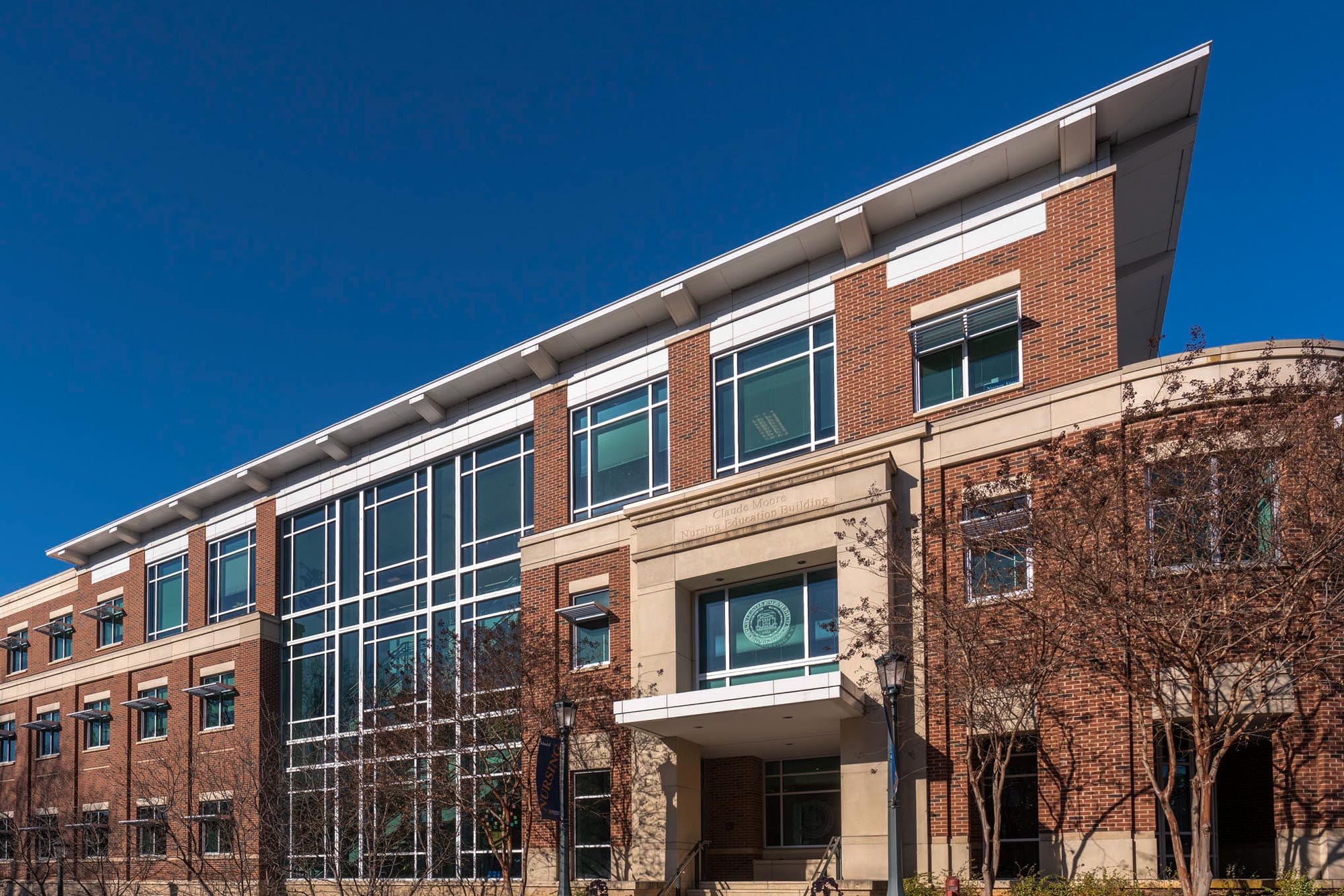 Brick building with a section of glass from top to bottom of the building