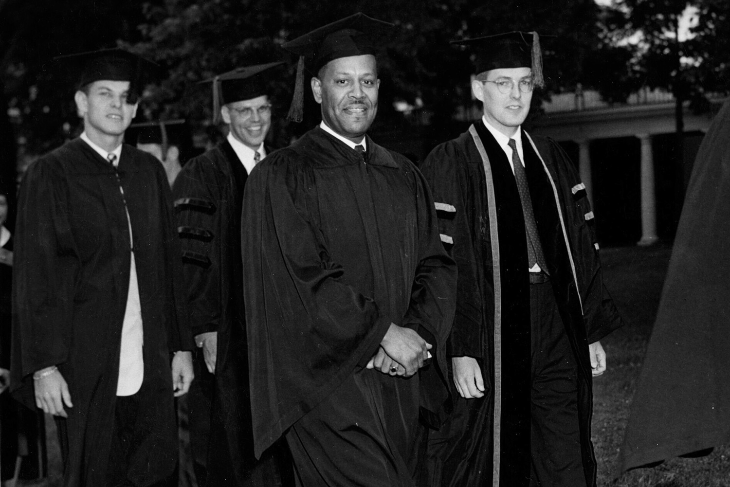 Walter F. Ridley walking the lawn during his graduation ceremony. Black and white image