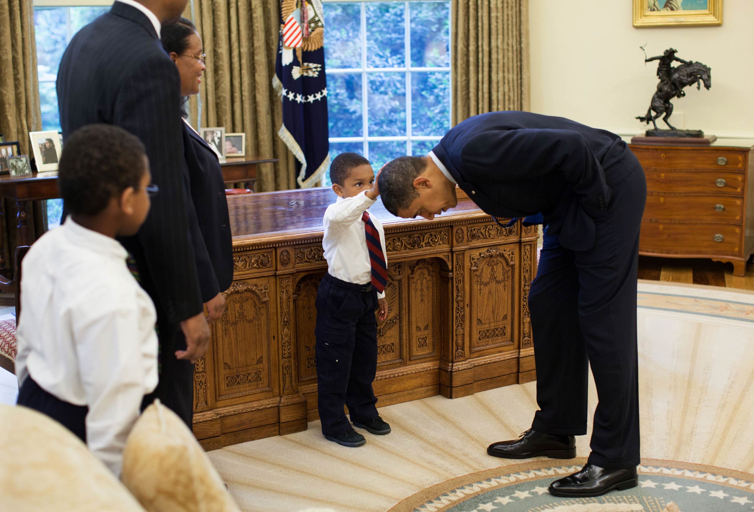 Obama letting a little kid touch his head