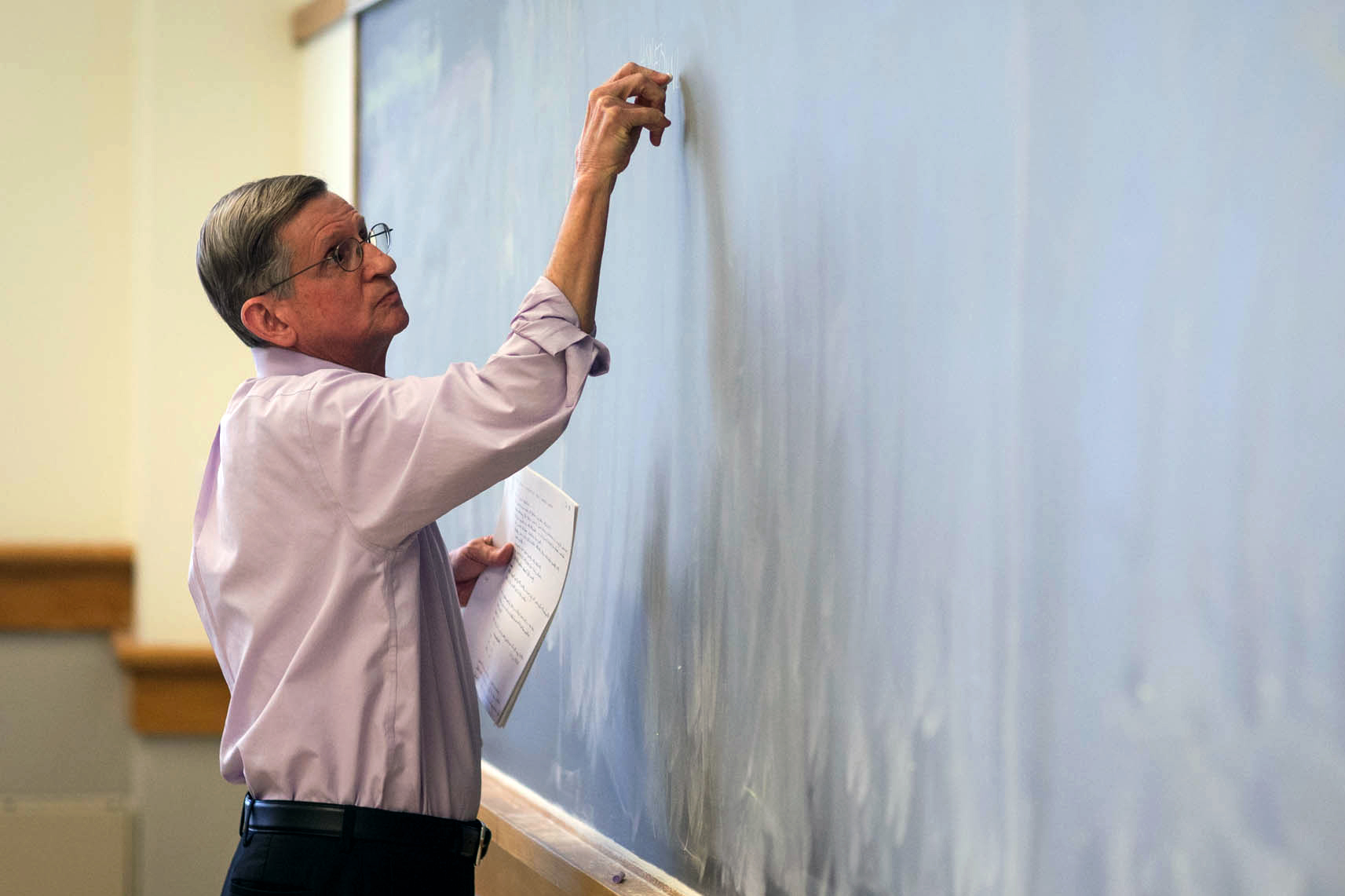 Ed Olsen writing on a chalkboard