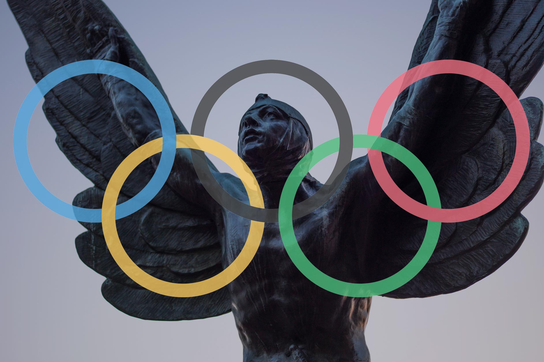 Flying man statue with Olympic rings over it