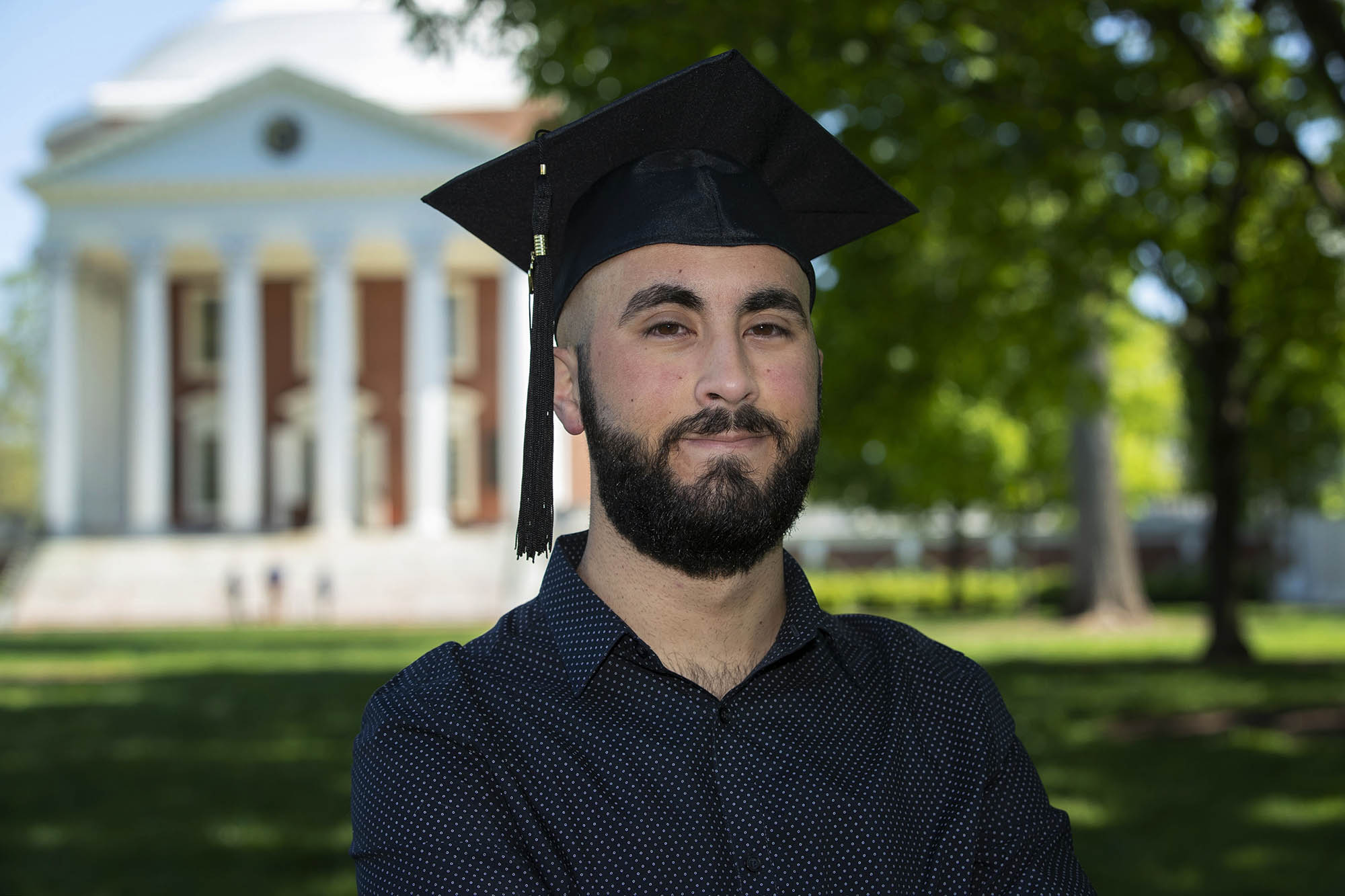 Omar Elhaj headshot with Graduation cap in front of the Rotunda