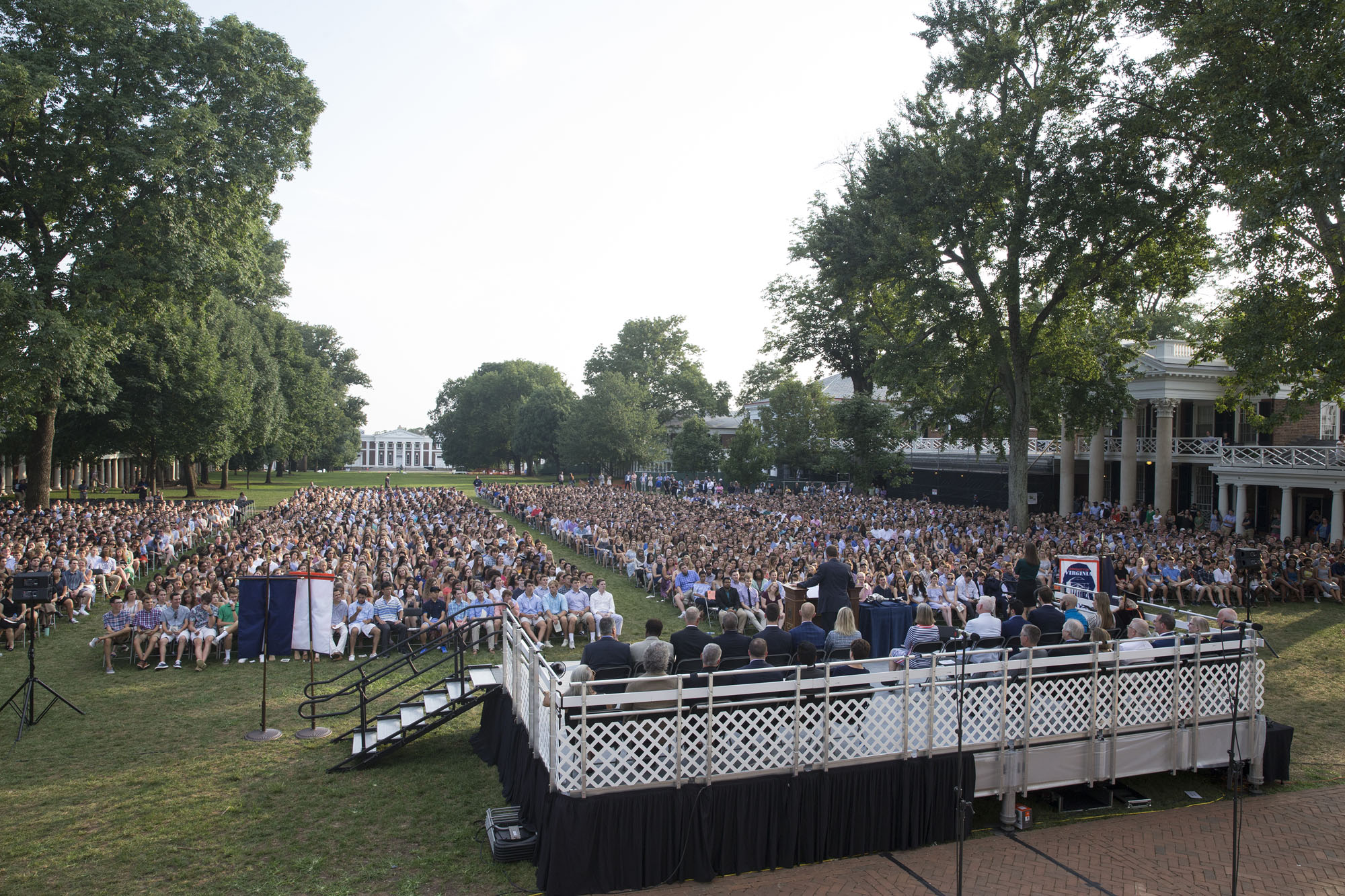 Class of 2022 sitting in chairs on the Lawn with President Ryan speaking from the Podium