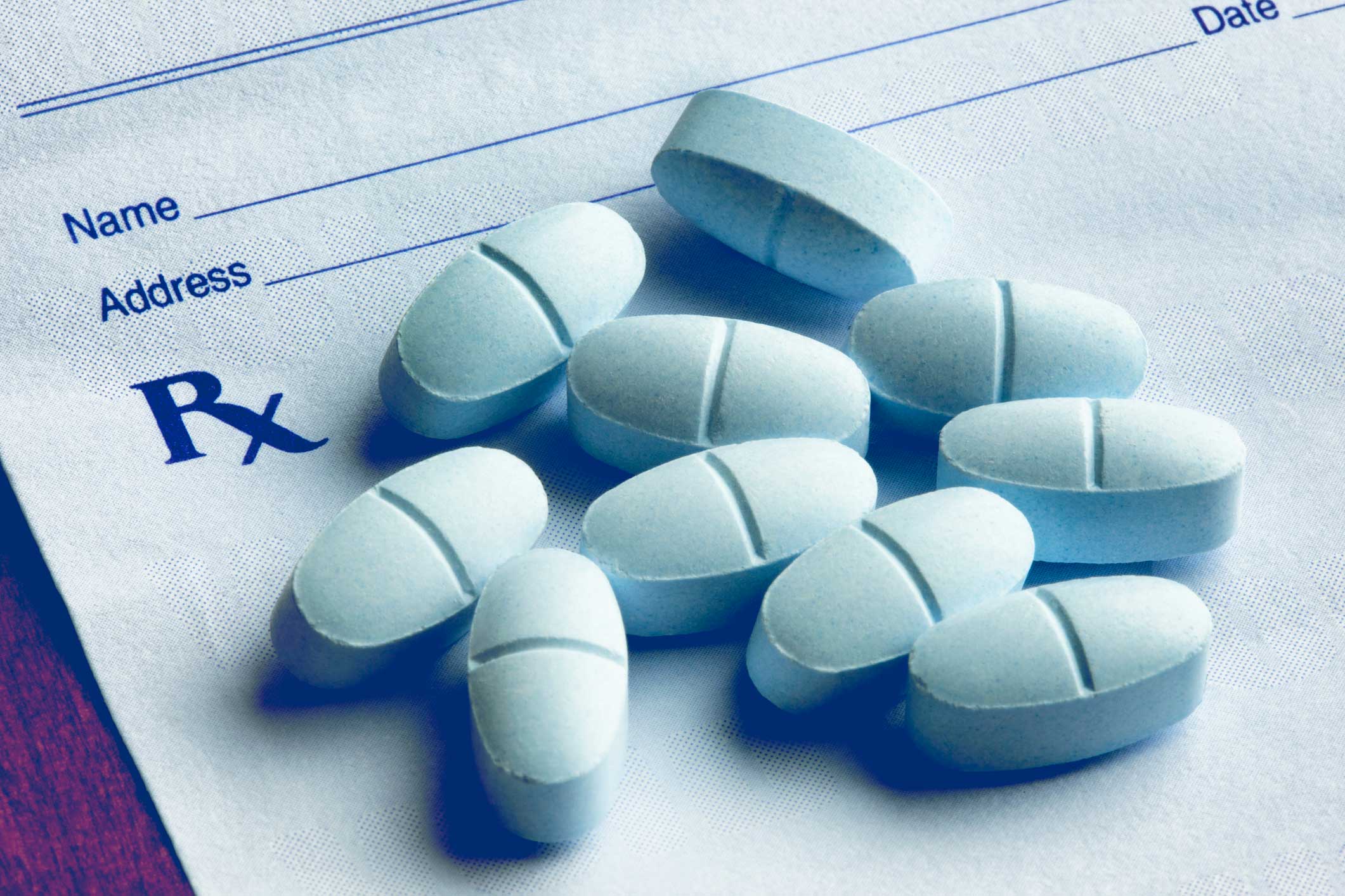 Pills sitting on top of a prescription pad