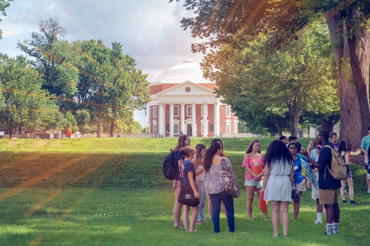 Students gather on the grass in front of the Rotunda