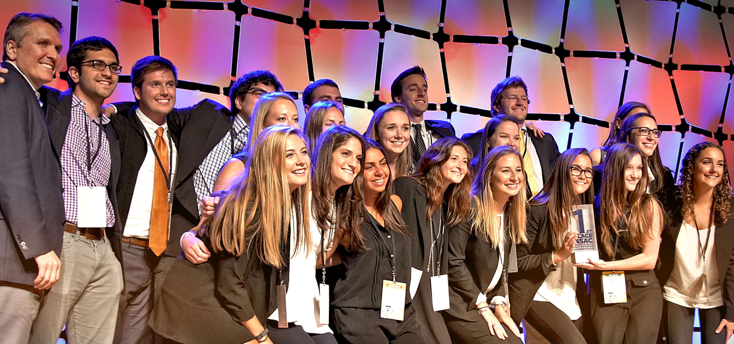 Professor Carrie Heilman, right, with her students posing with their trophy after winning the American Advertising Federation’s 2016 National Student Advertising Competition.