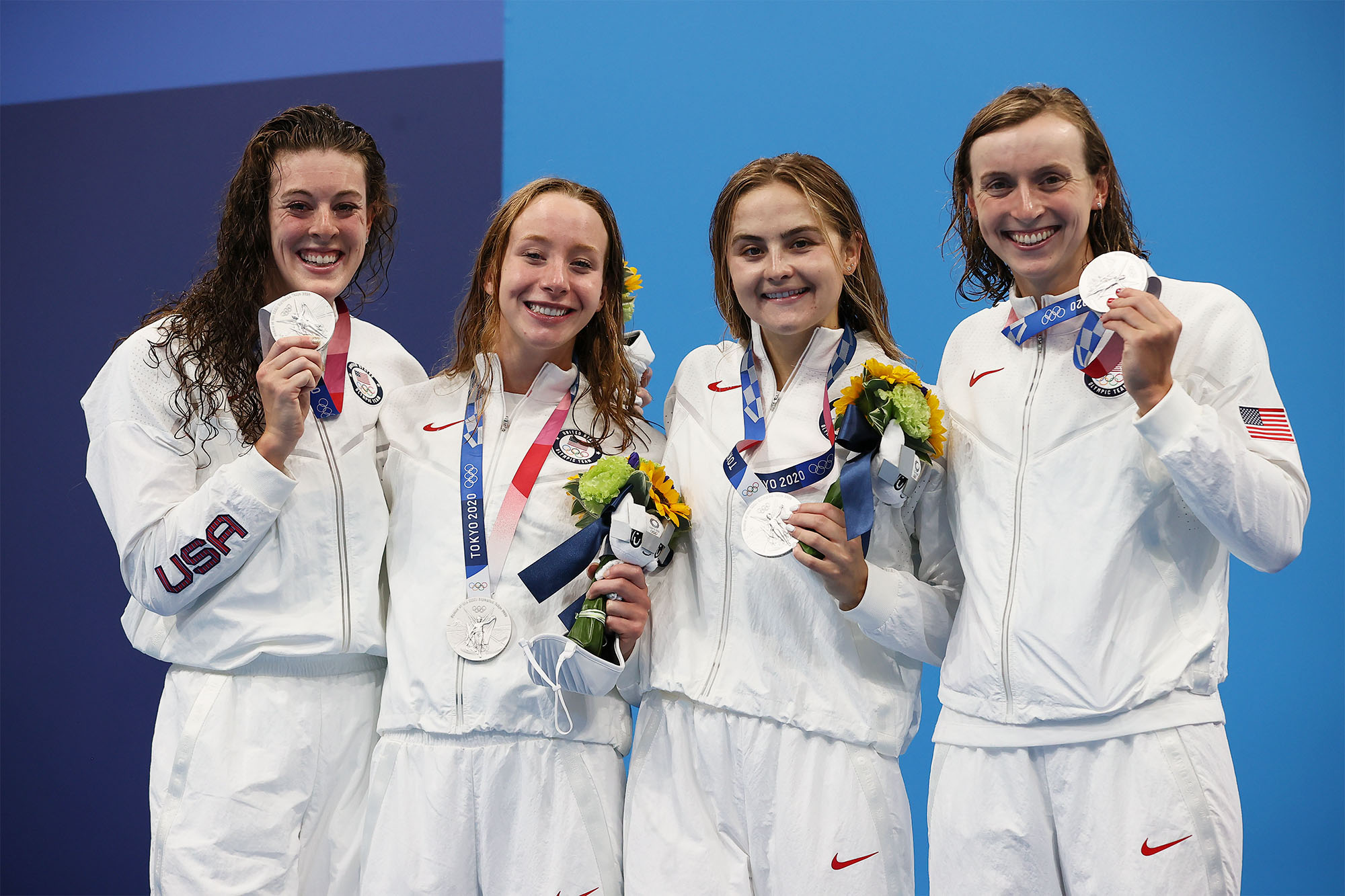 Madden, second from left,  stands with the USA womens olympic relay swimming team holding their silver medals
