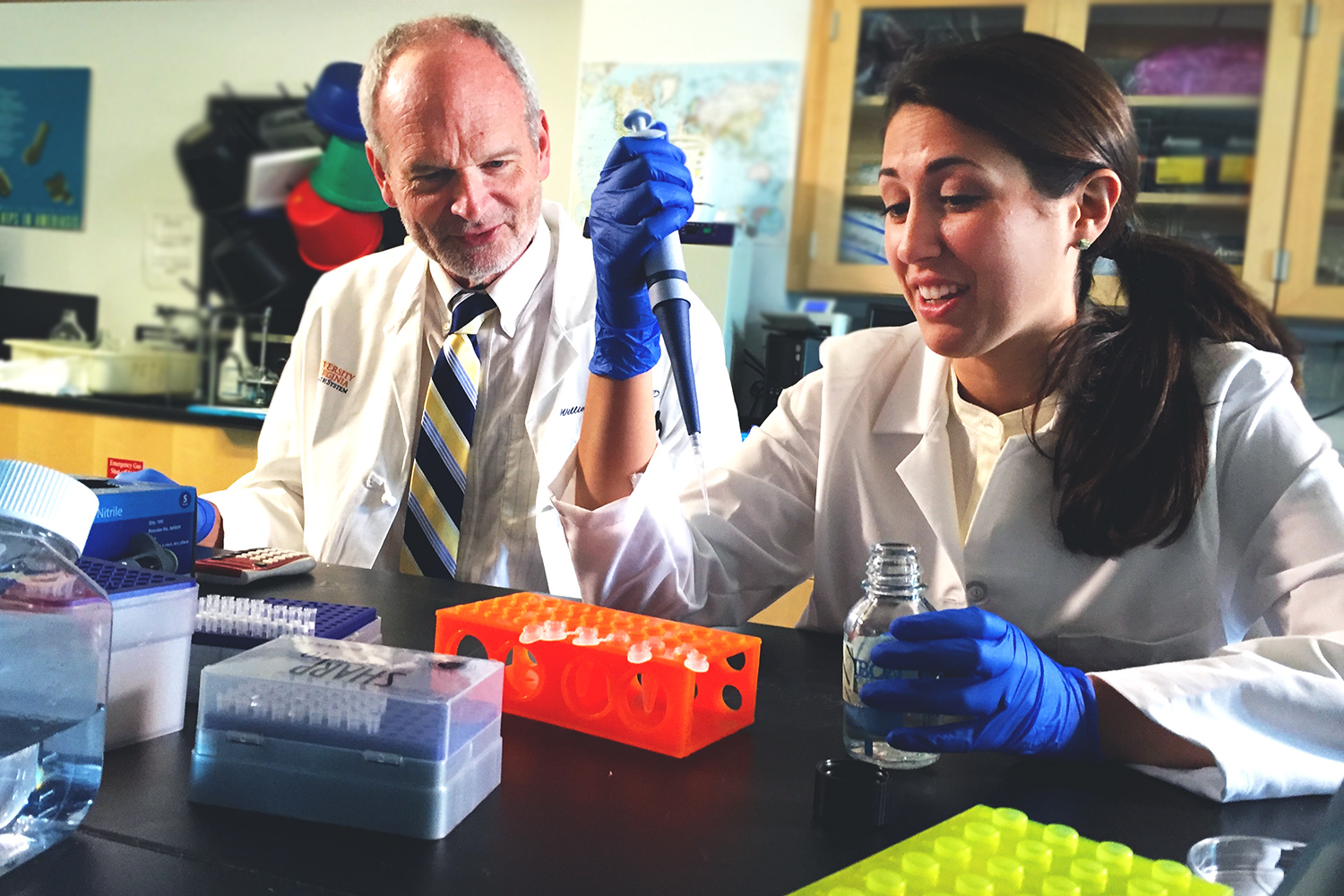 Dr. Bill Petri, left, and Erica L. Buonomo working in a lab together