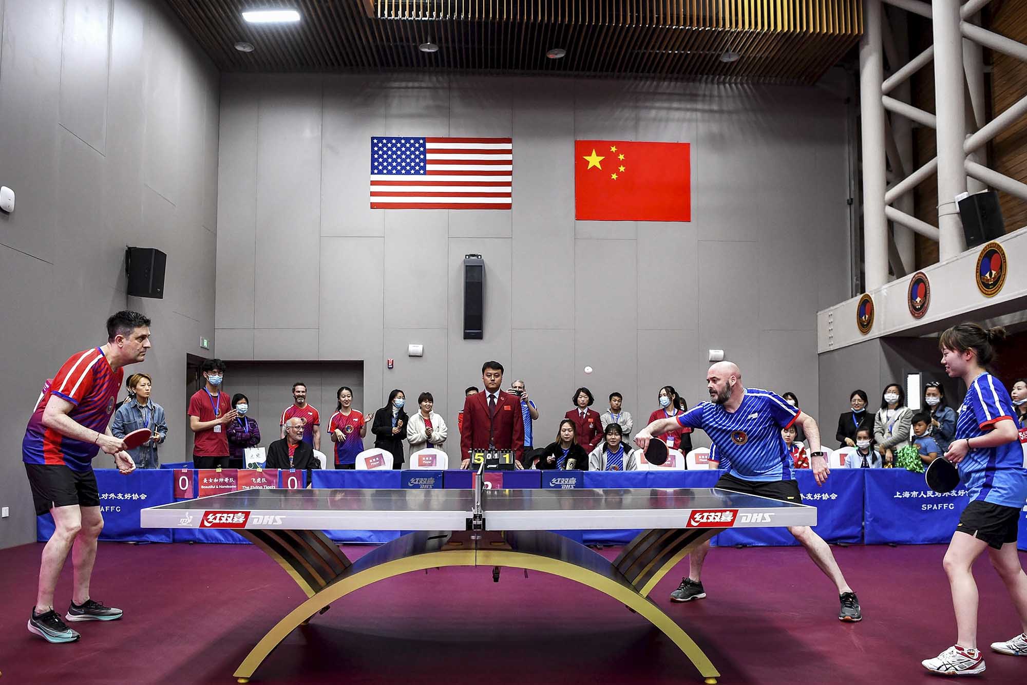 Justin O’Jack, left, receives a serve from Corey Skelton at the International Table Tennis Federation Museum
