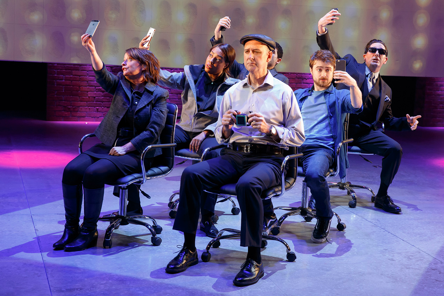 Cast on stage taking selfies during a performance. From left to right: Rachel Dratch, De’Adre Aziza, Michael Countrymen, Daniel Radcliffe and Reg Rogers. Raffi Barsoumian