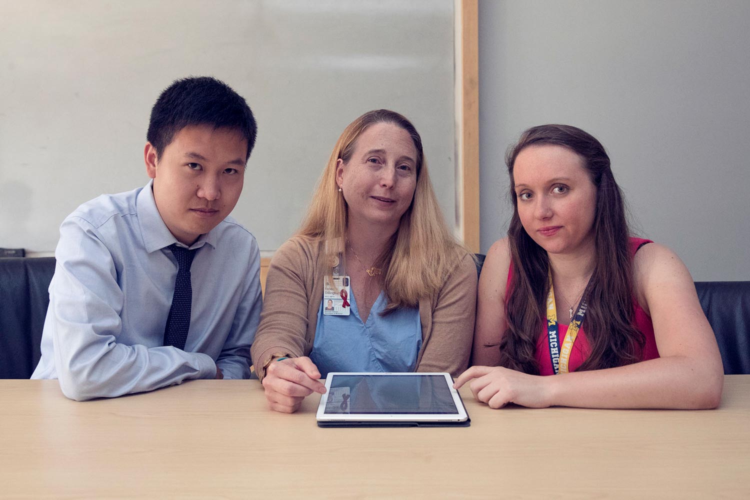 Tianyi Jin, Dr. Rebecca Dillingham; and Marika Grabowski sit at a table smiling