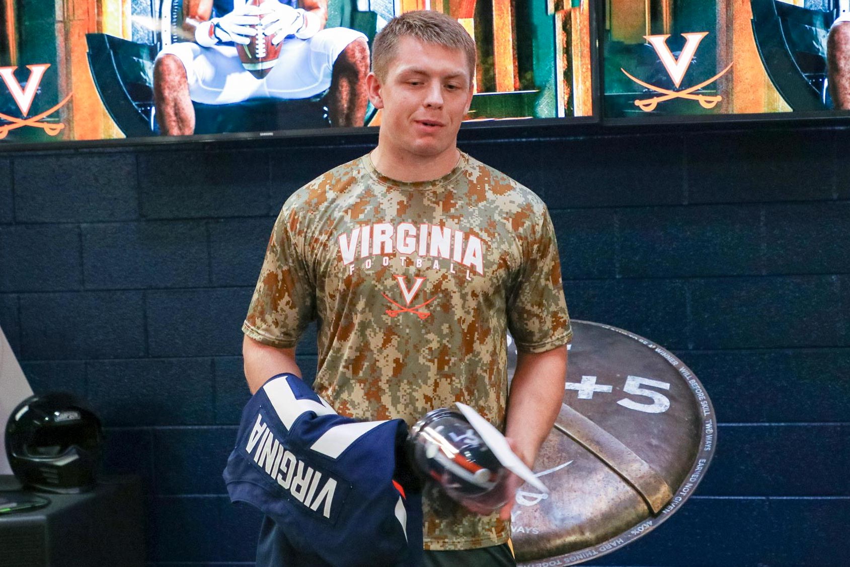 Reed Kellam holding UVA football swag