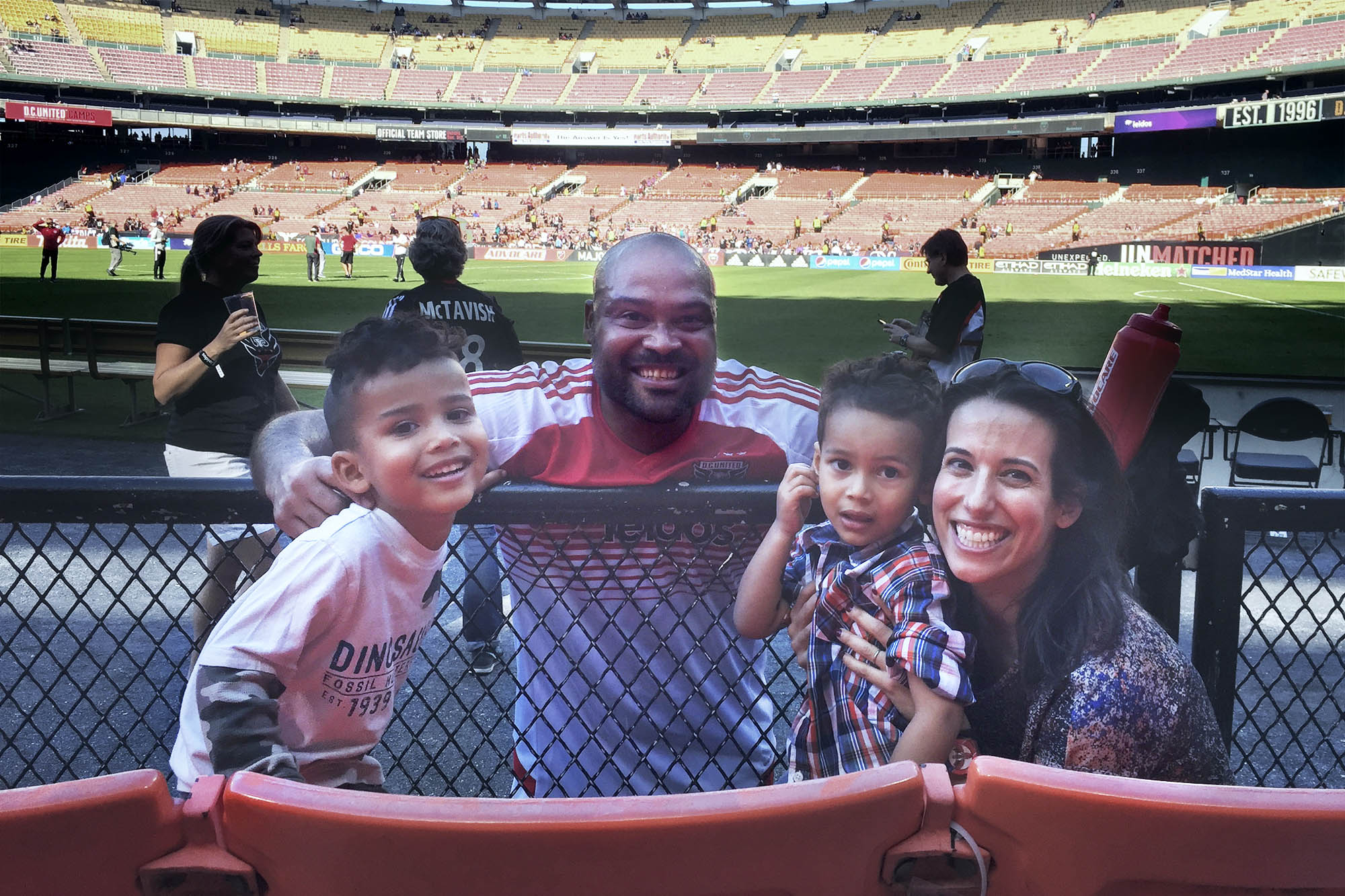 Robbie Russell posing with his family at a soccer game