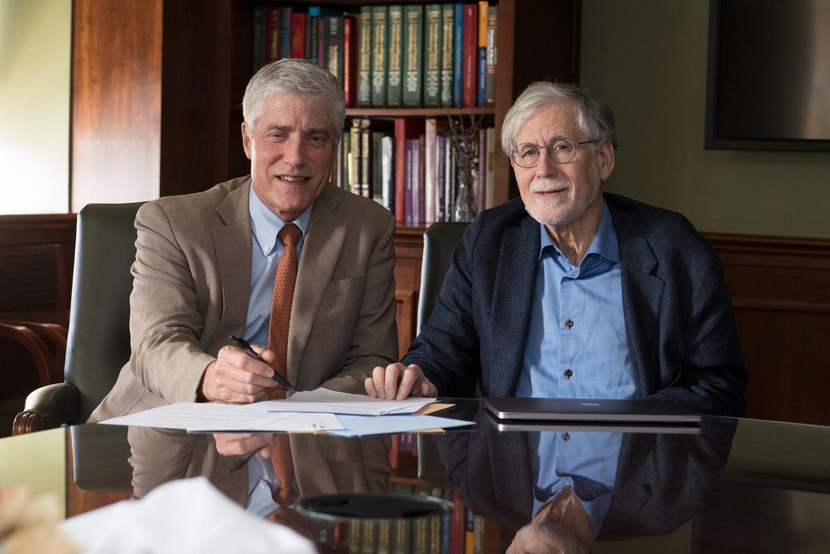 Dr. Peter Netland, left, and Robert Grainger, right, sit at a table together