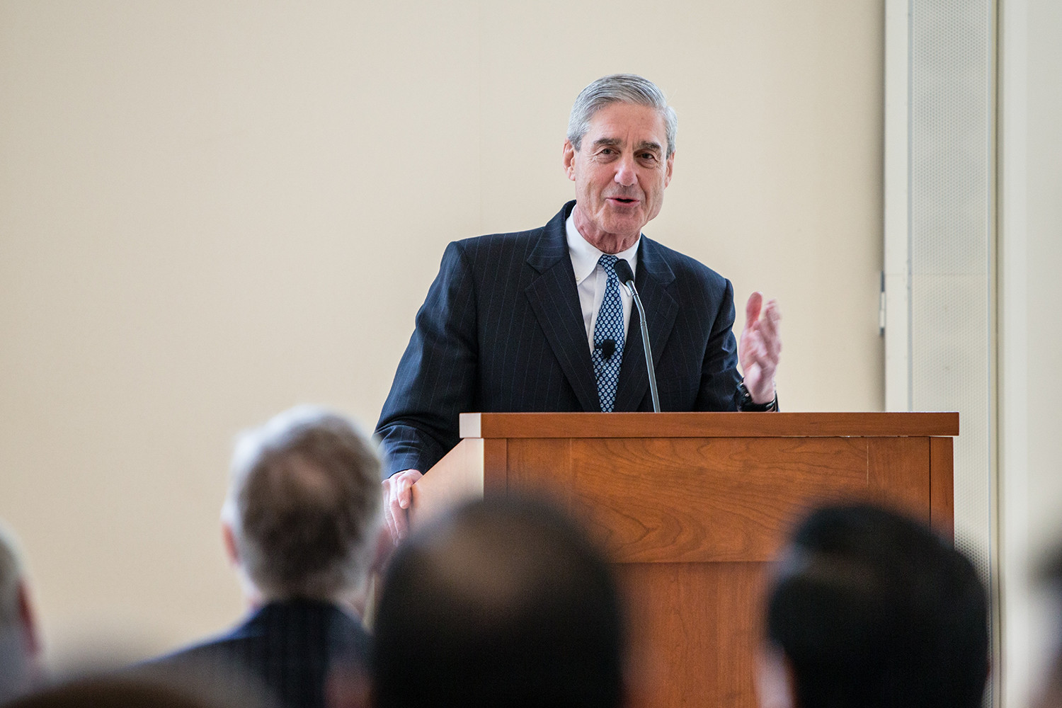 Robert S. Mueller III speaking to a crowd from a podium
