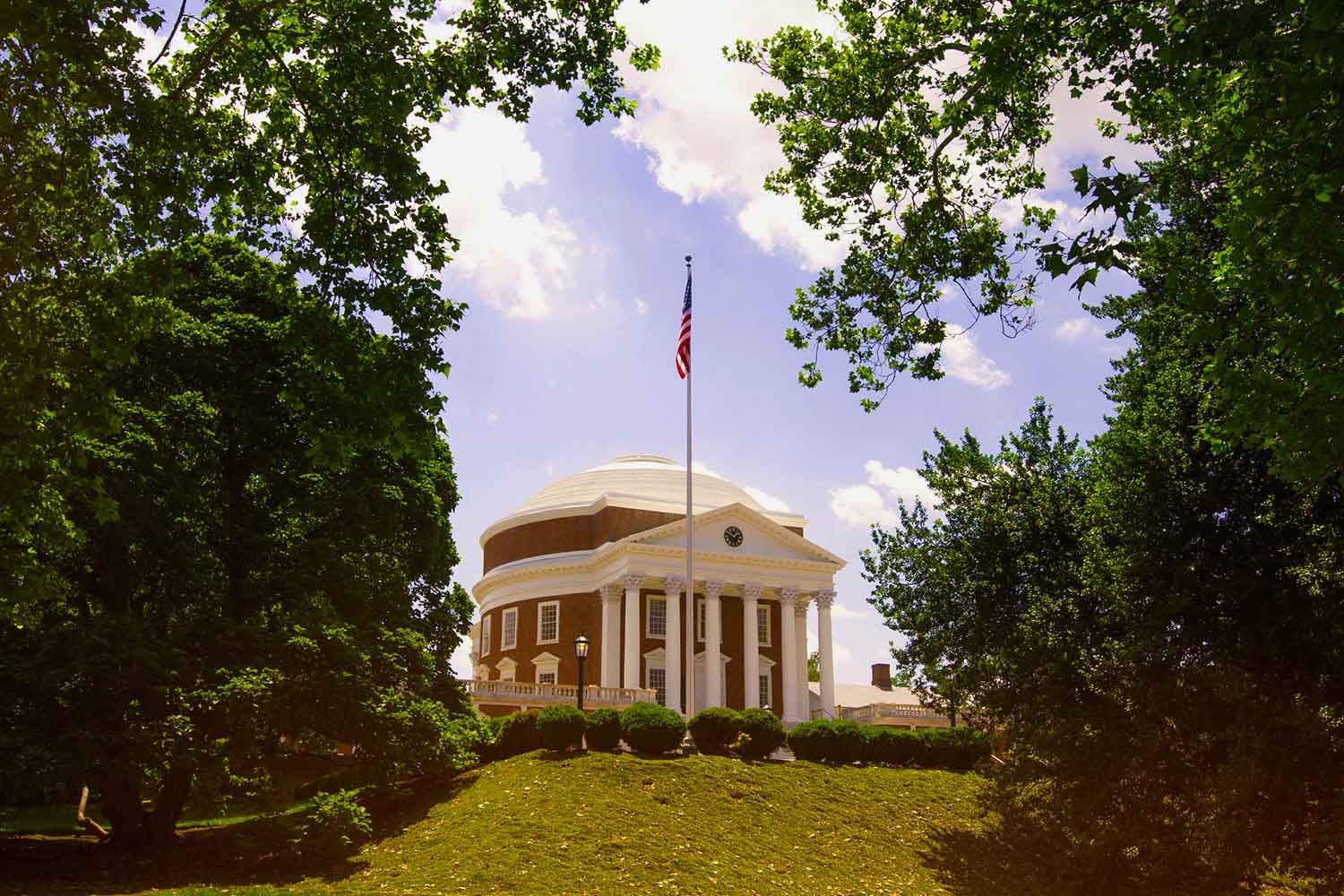 The Rotunda with an American flag in front on a pole