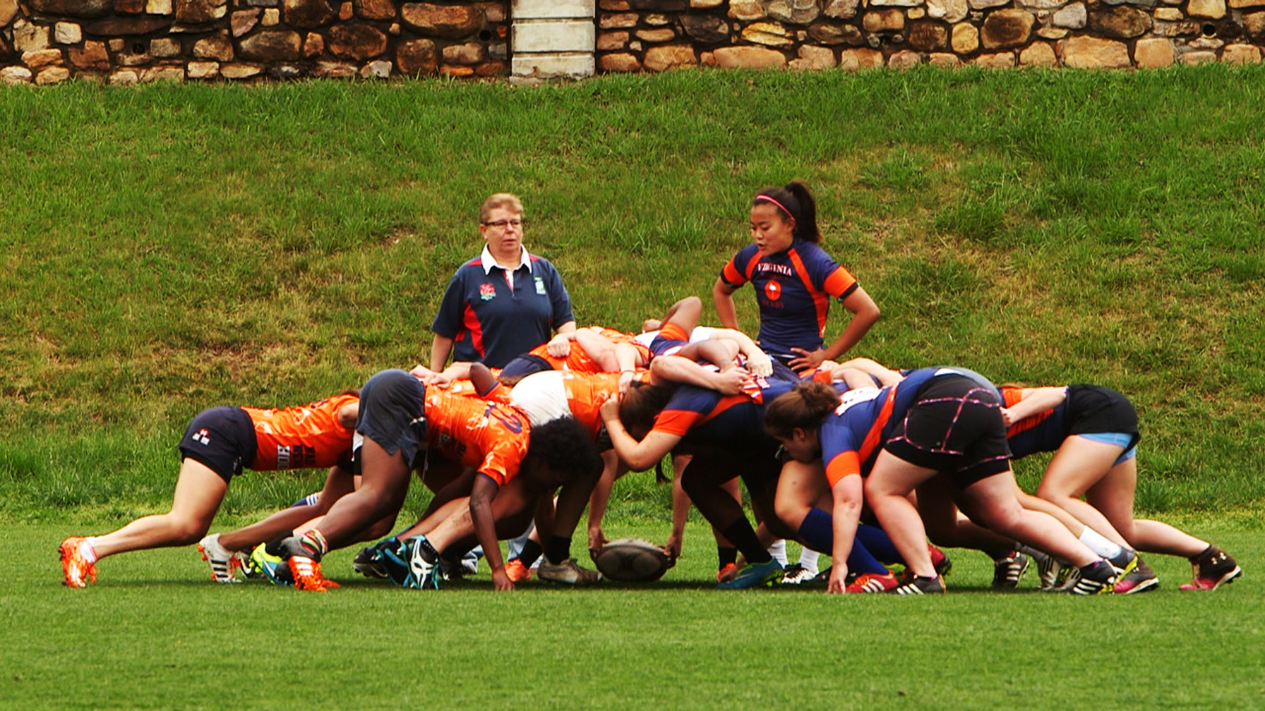 Woman's UVA Rugby team practicing on the field