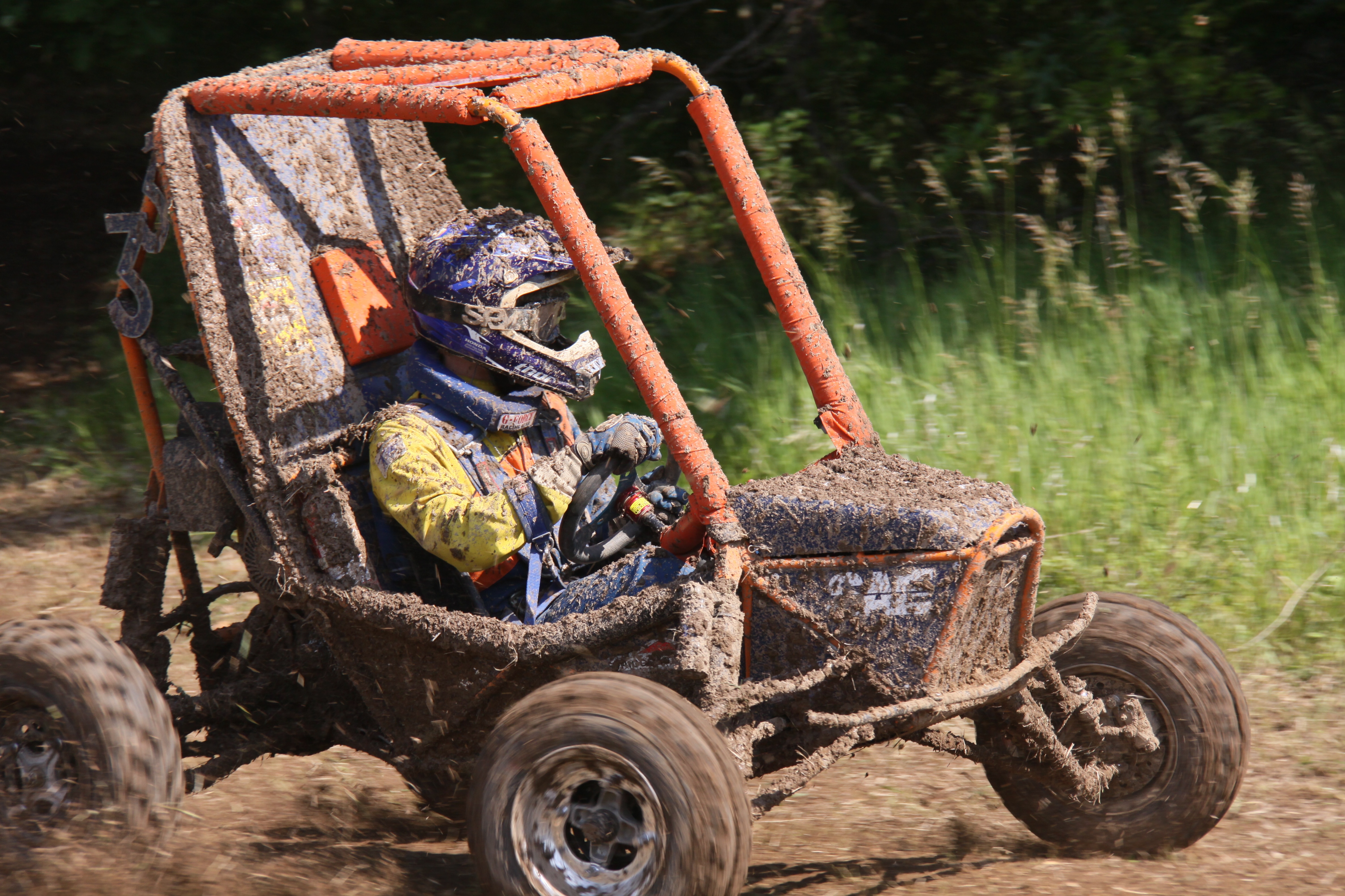 Baja racing a go cart in the mud