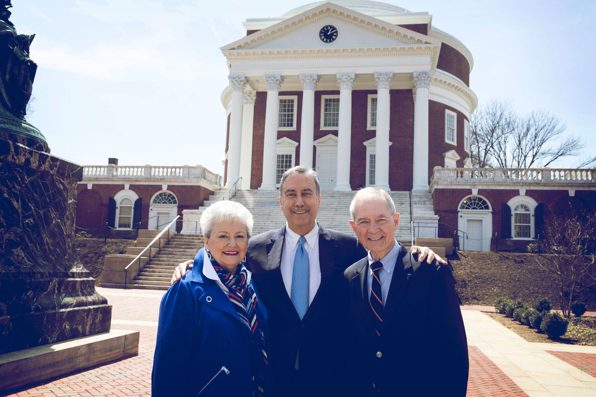 Larry Sabato, center, and Leonard and Jerry Sandridge stand together in front of the Rotunda