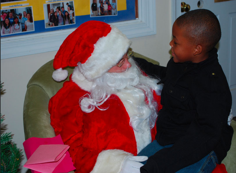 Santa holding a little kid on his lap