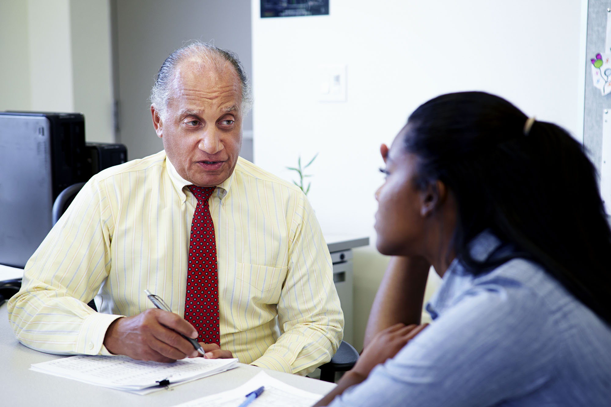 Two people sitting at a table talking