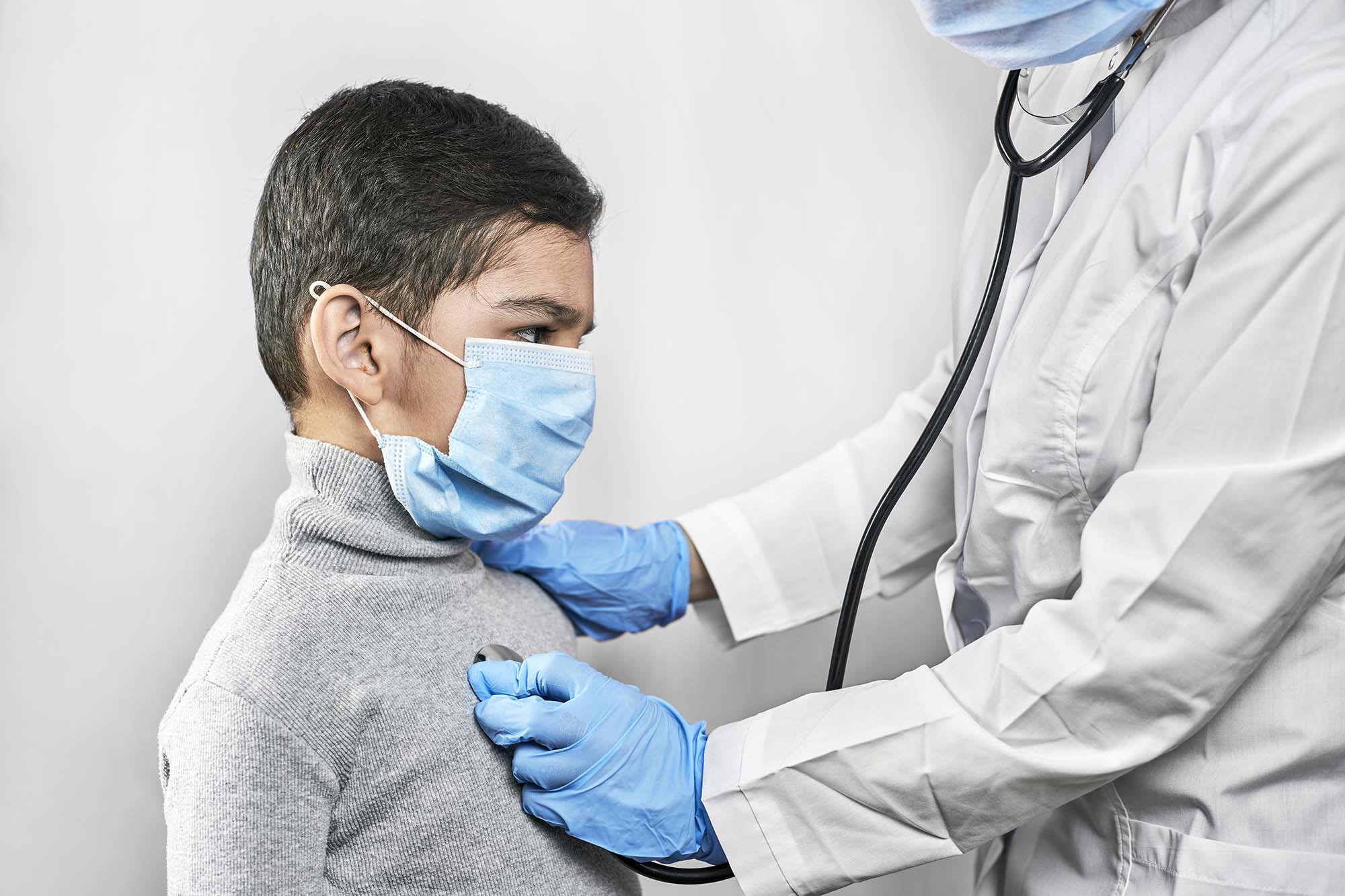 Doctor listening the lungs of a child