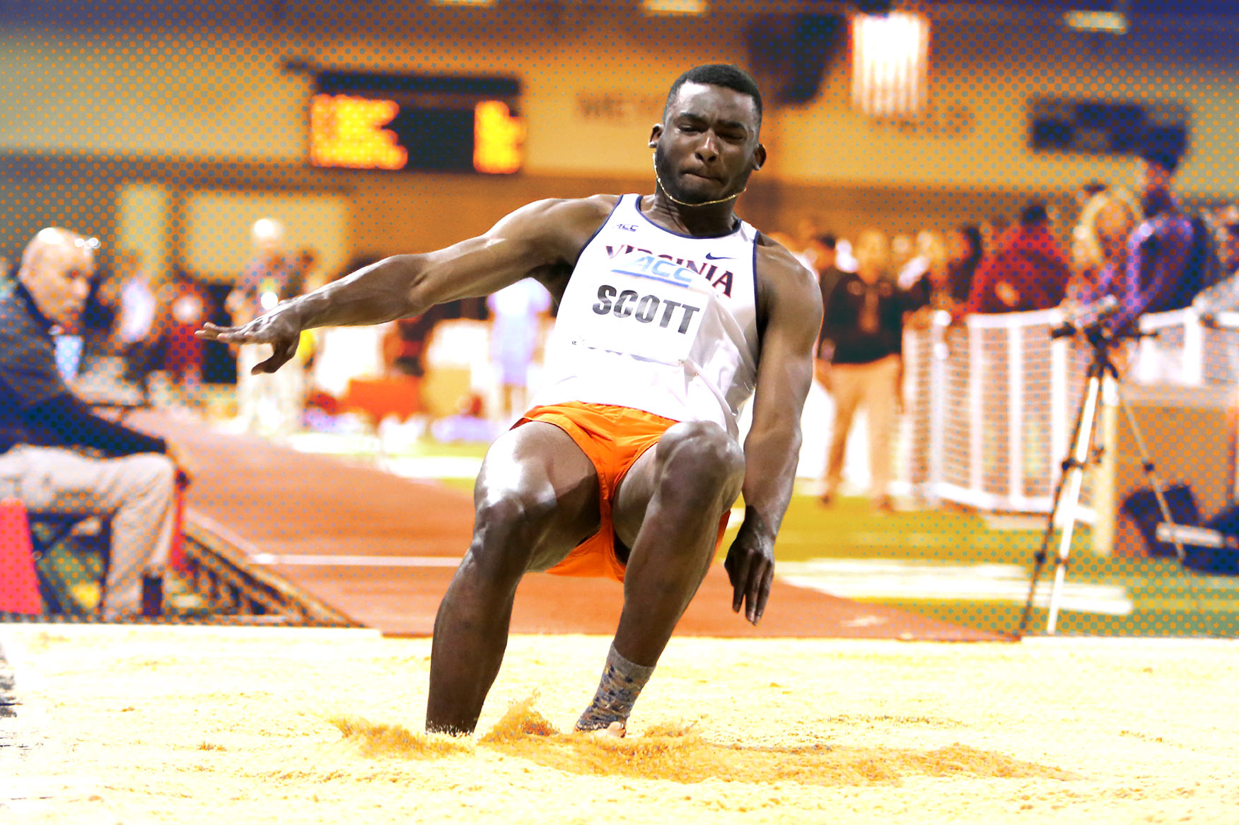 Jordan Scott landing in the sand pit after his long jump during a tack meet
