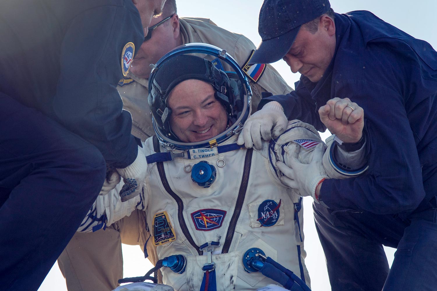 Scott Tingle is helped out of the Soyuz MS-07 spacecraft