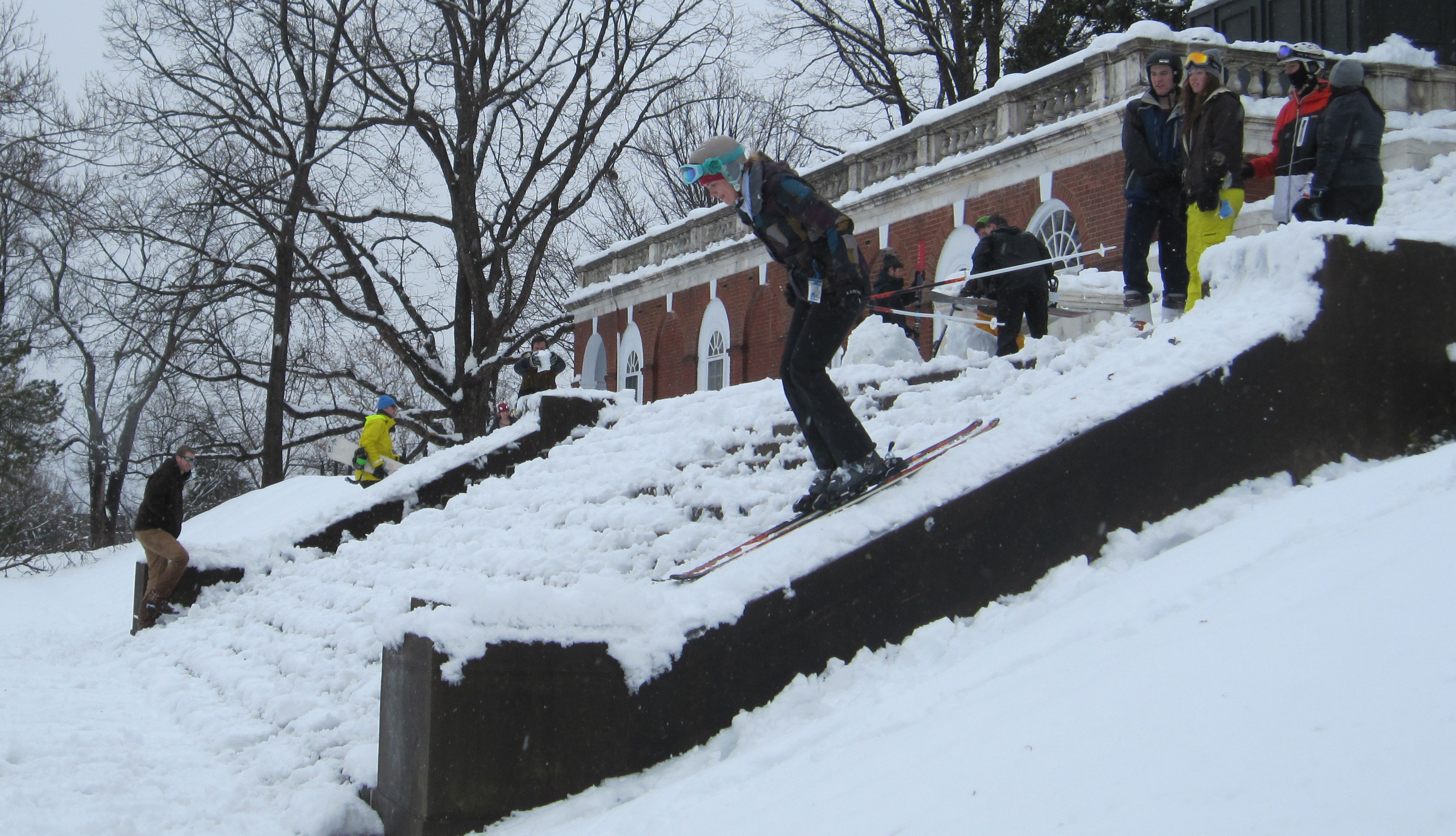 Students skiing down steps on grounds