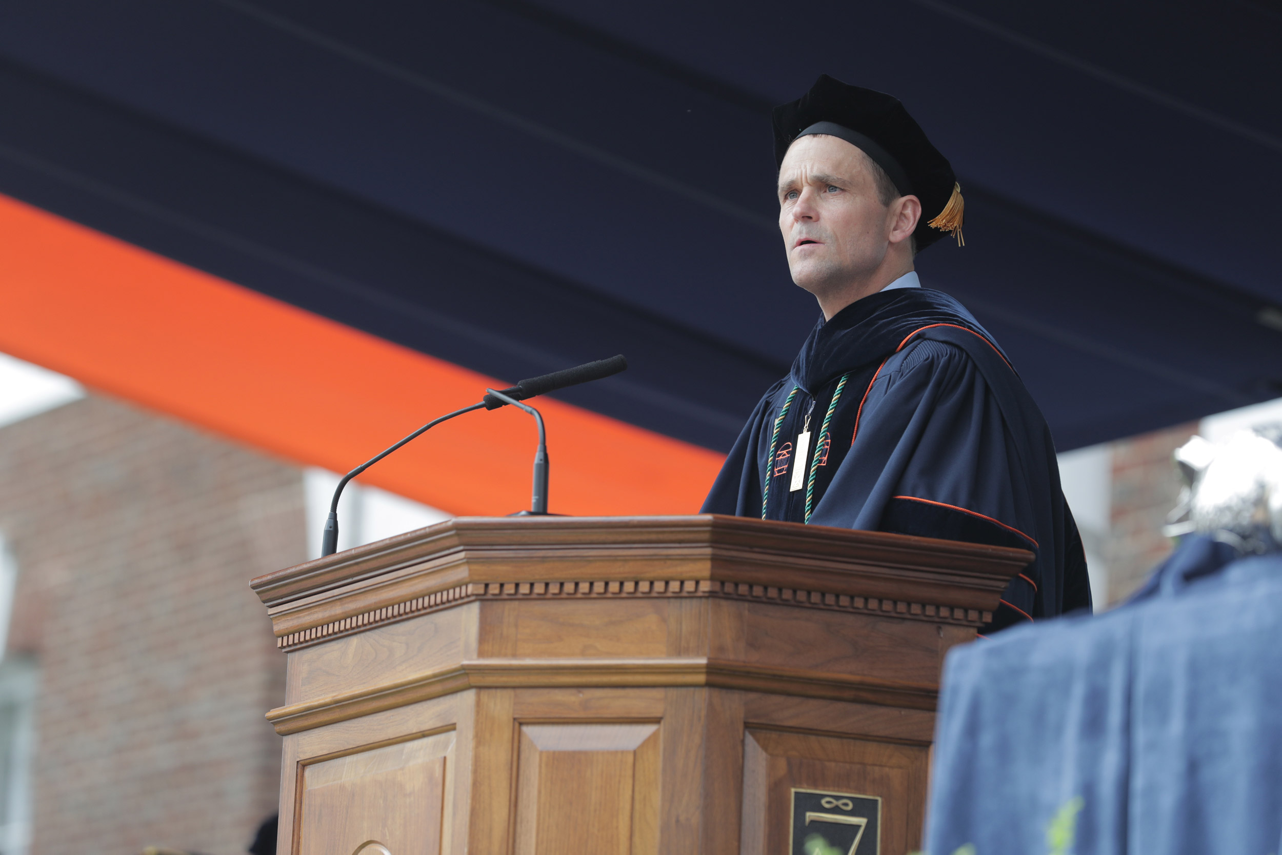 President Jim Ryan stands at a podium giving a speech