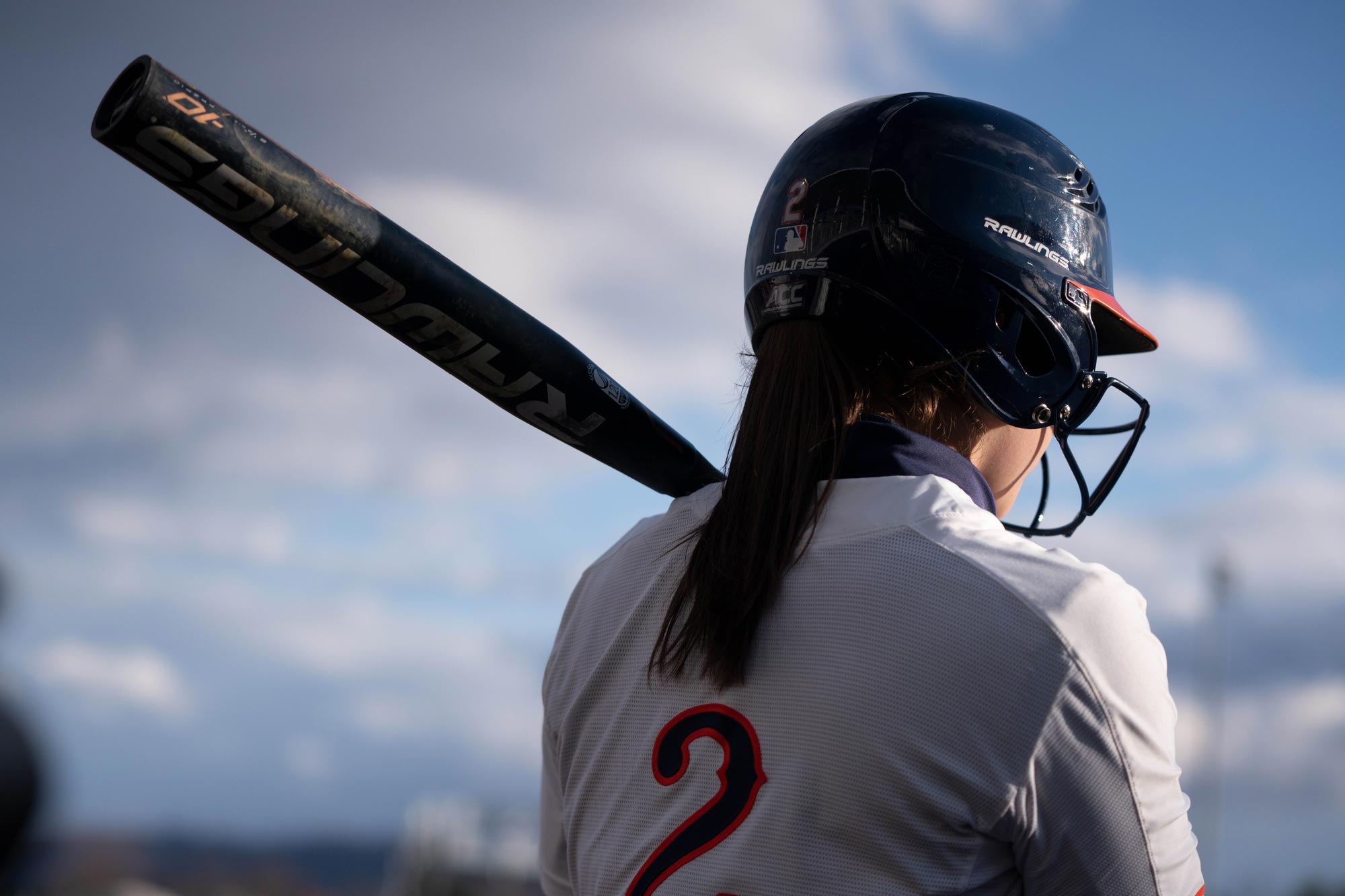 Softball player holding a bat during a game