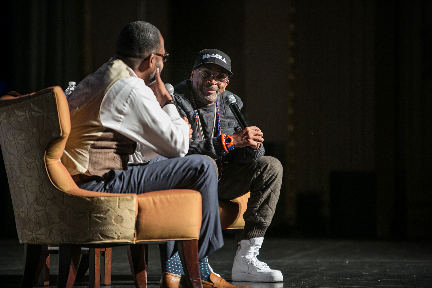 Spike Lee and Maurice Wallace talk on stage in front of a crowd