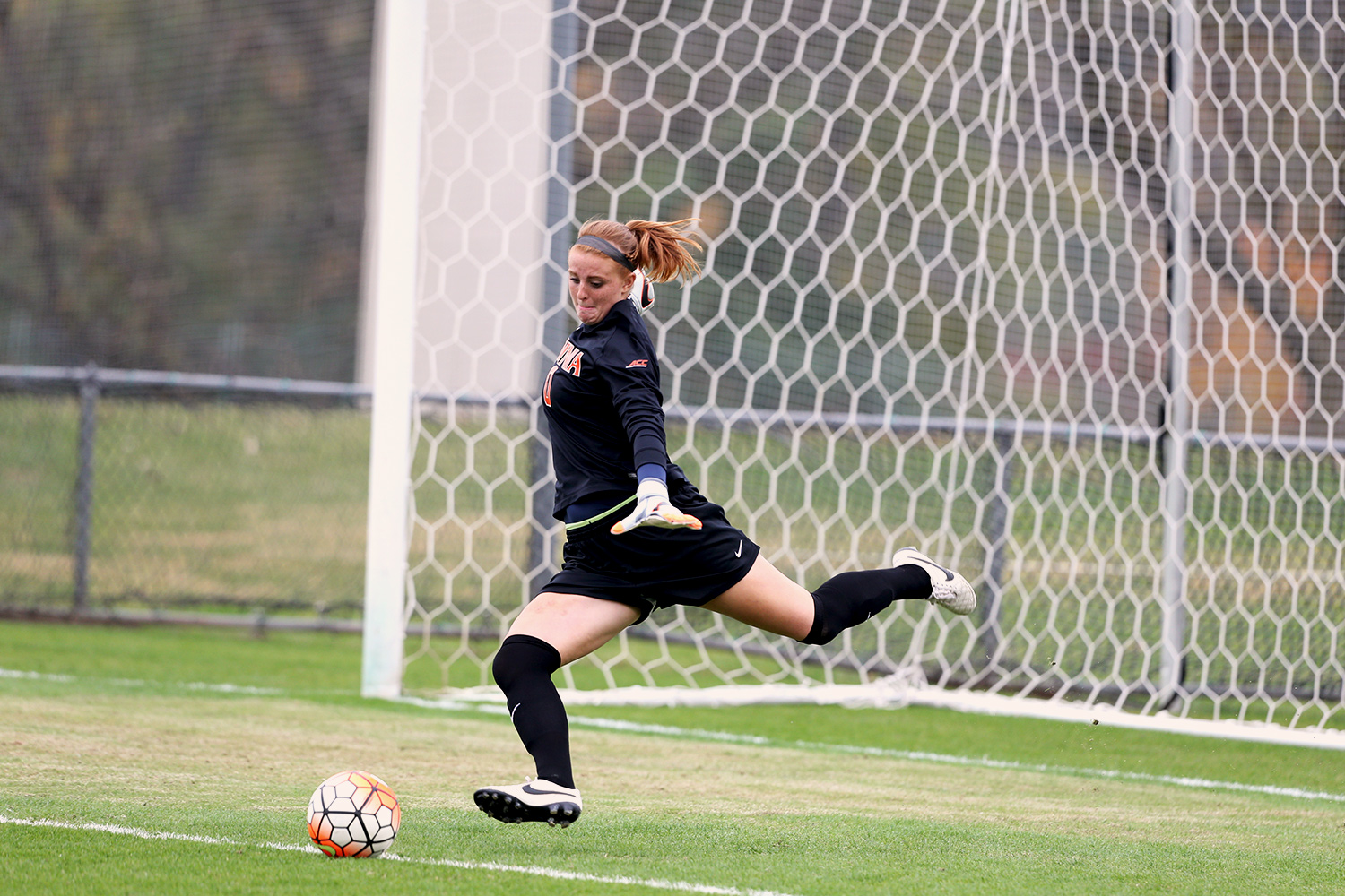 Morgan Stearns kicking a soccer ball during a practice