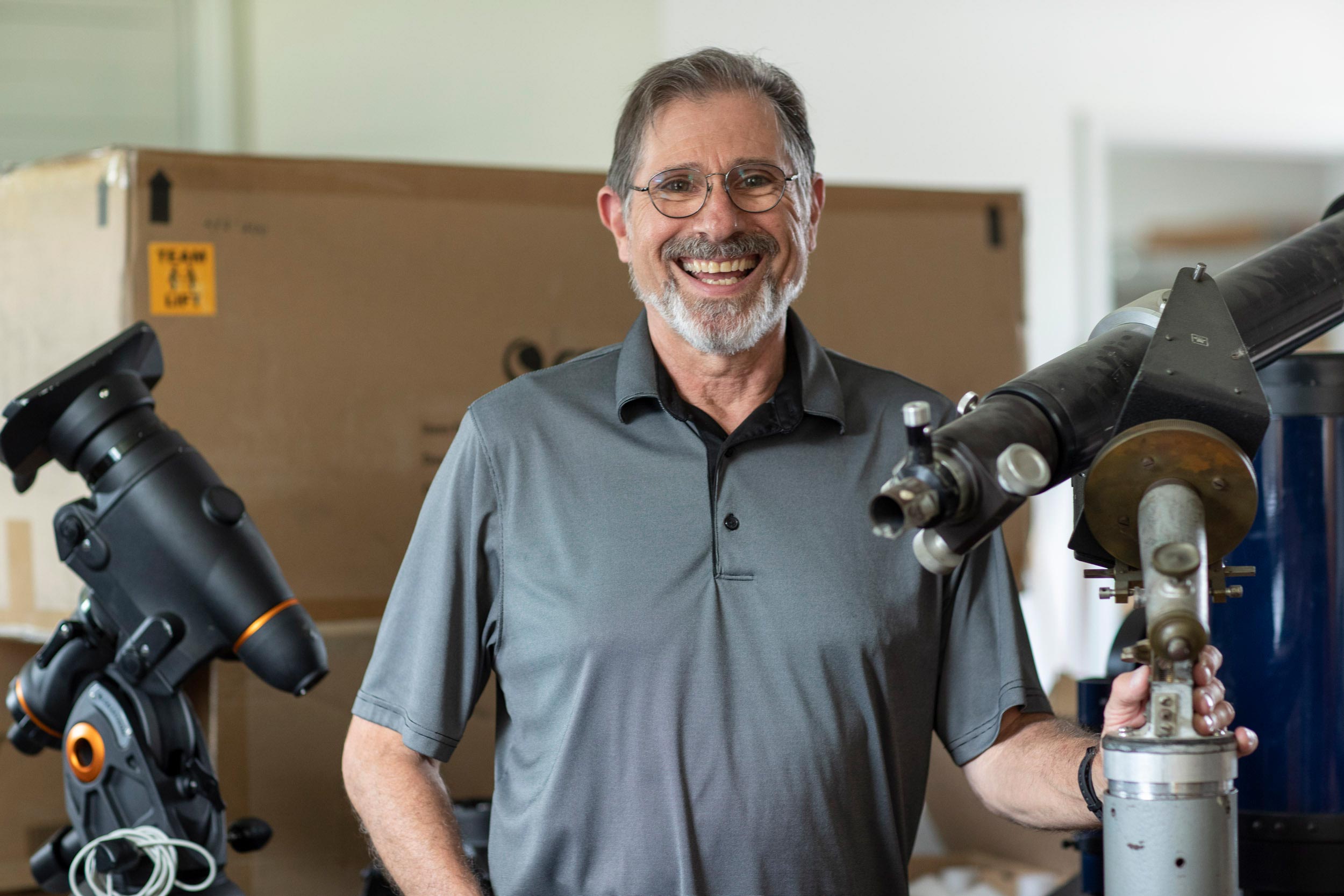 Steve Layman headshot with telescopes