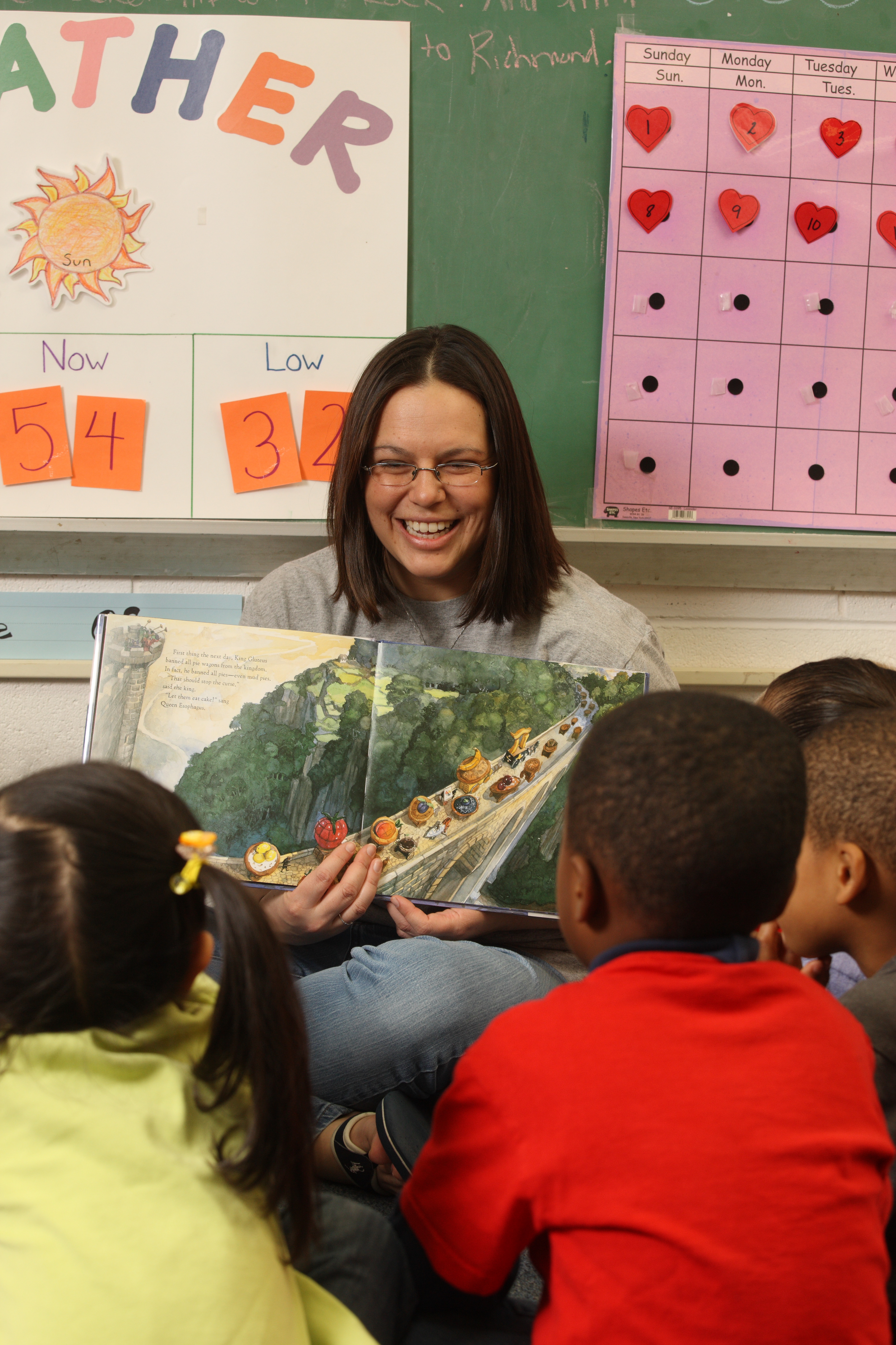 Teacher reading to a group of elementary students