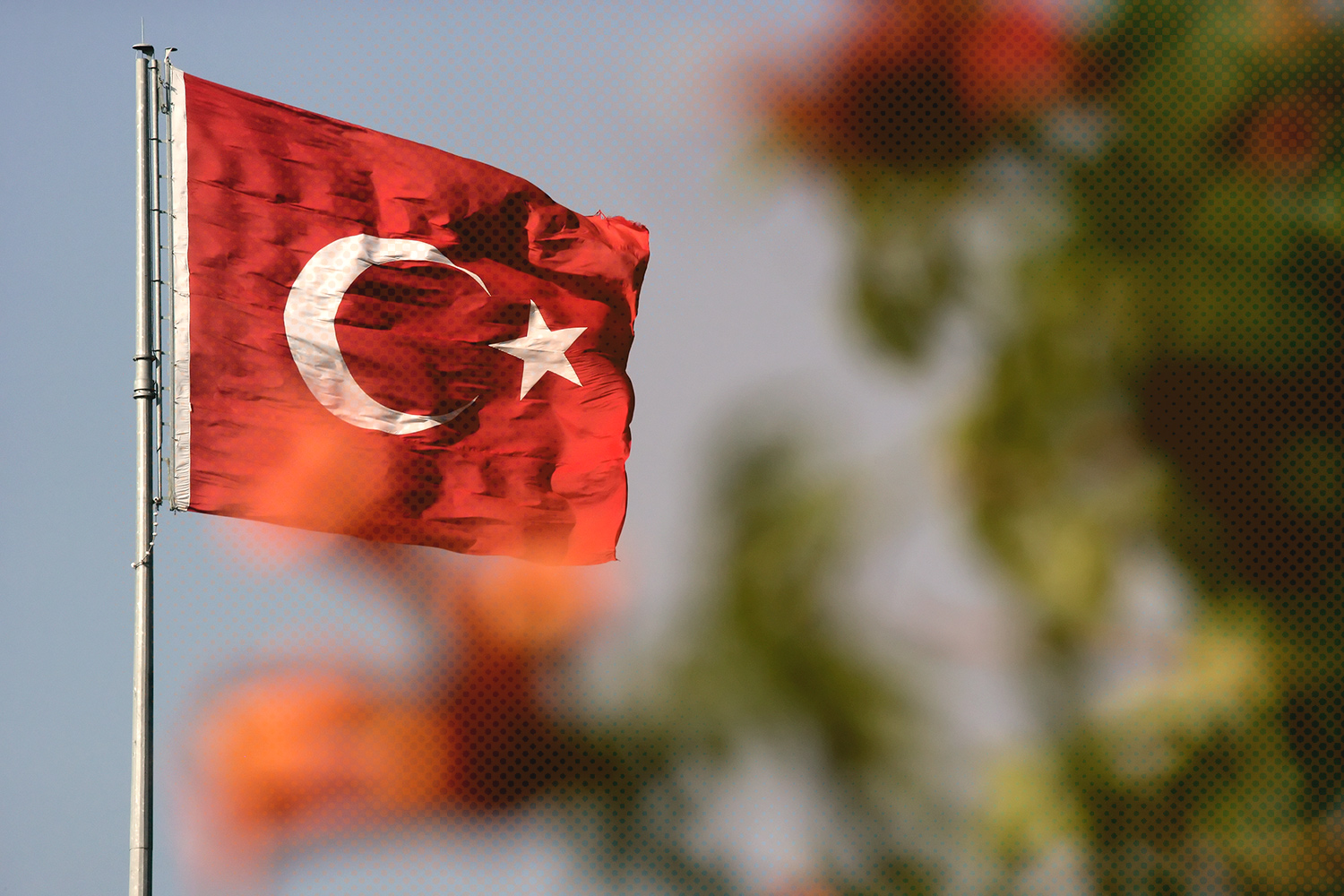 Turkish flag on a flag pole blowing in the wind