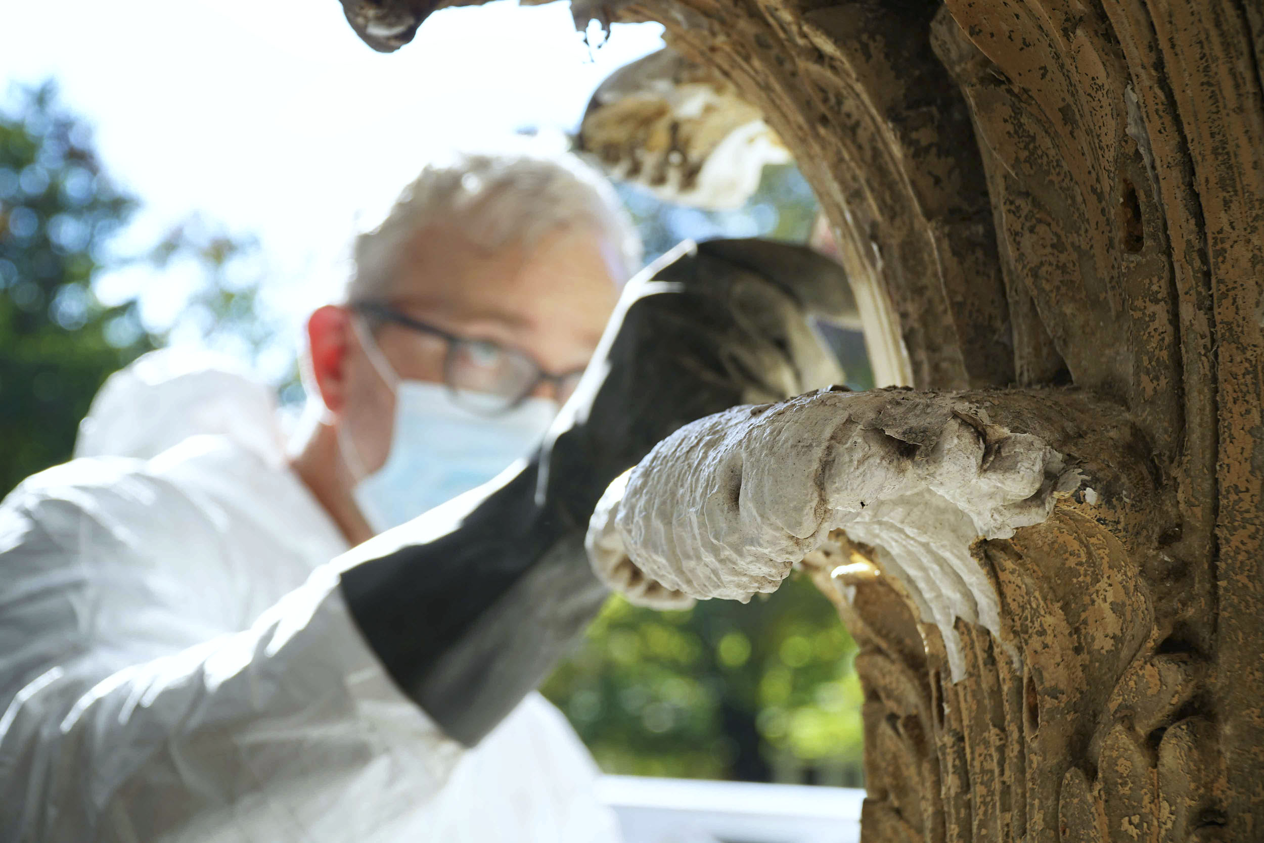 Lee Dunsmore wears globes as he examines a concrete structure