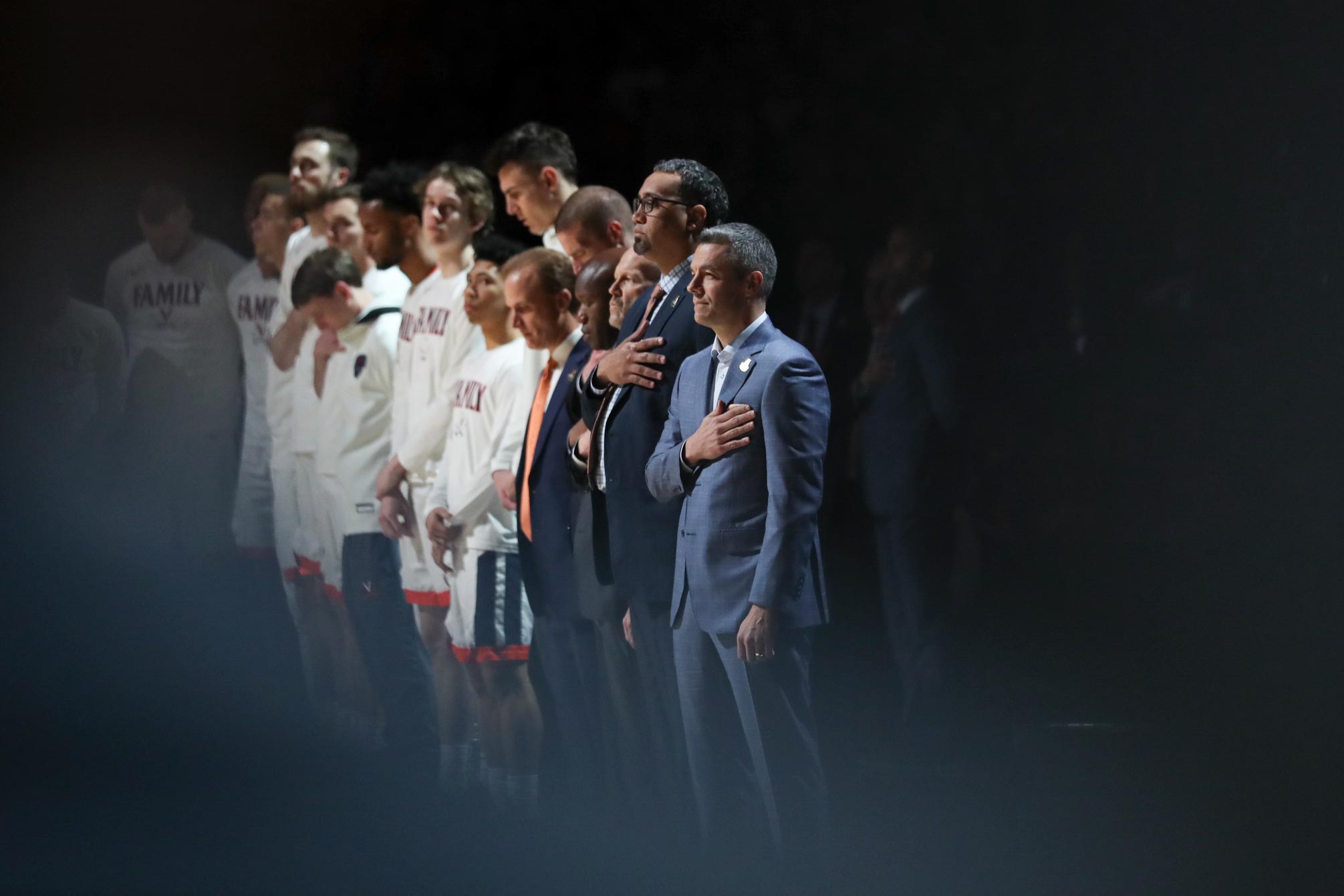 Tony Bennett and basketball team stands respectfully for the National Anthem