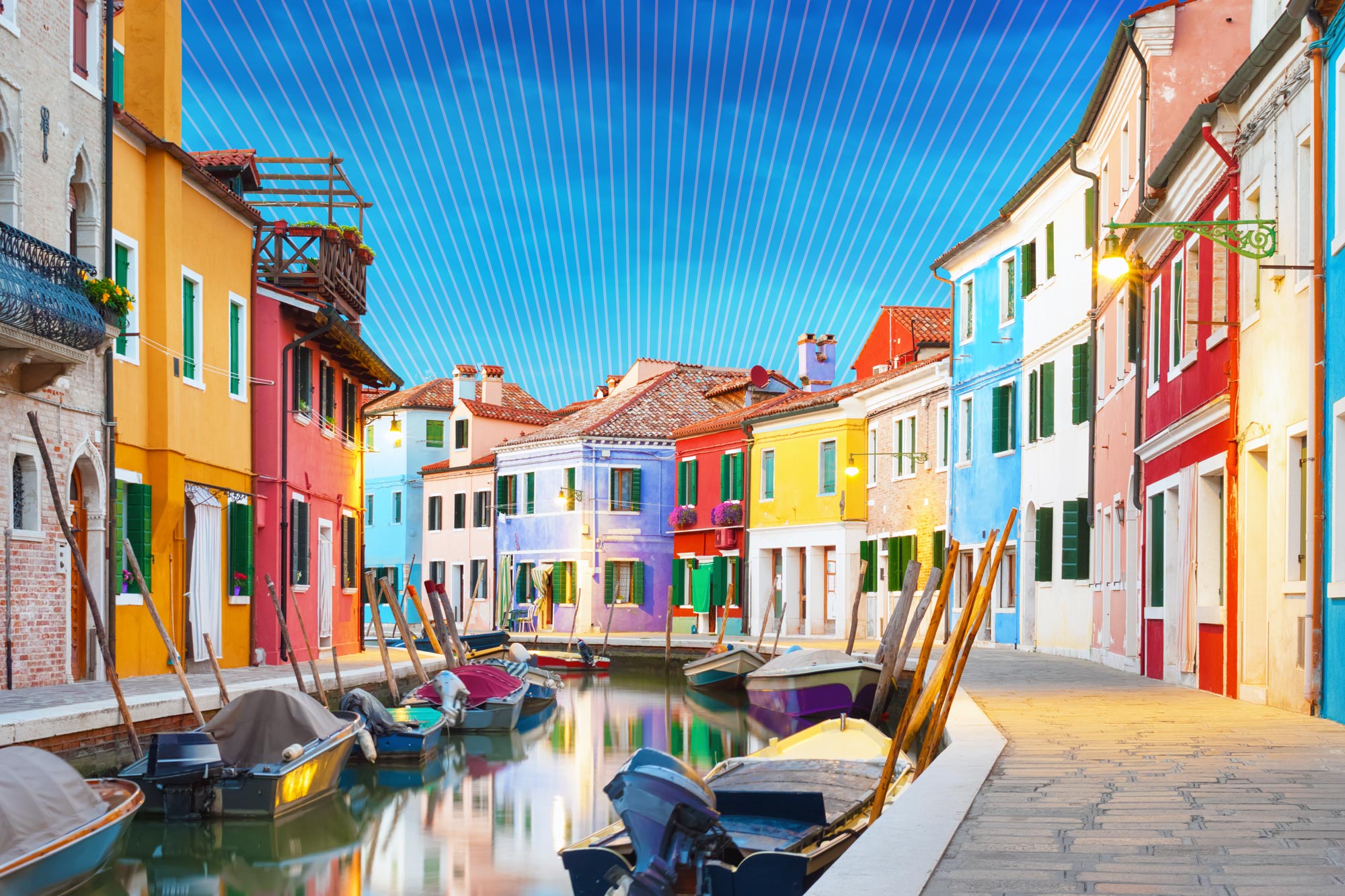 Buildings in various colors with boats in the water in Venice Italy