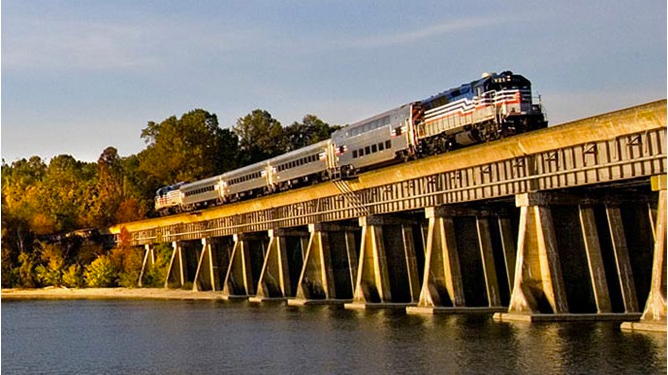 Amtrak train going across a bridge